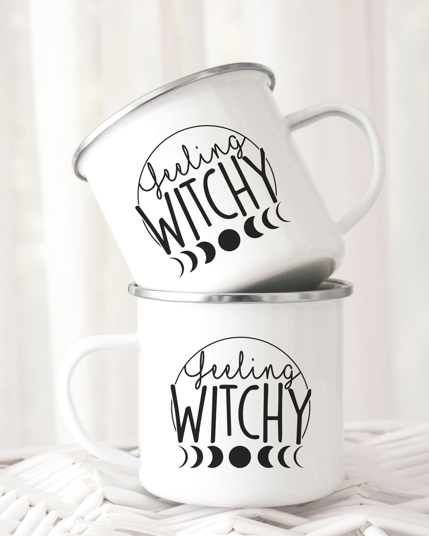 Two white mugs with 'Feeling Witchy' text on a white background