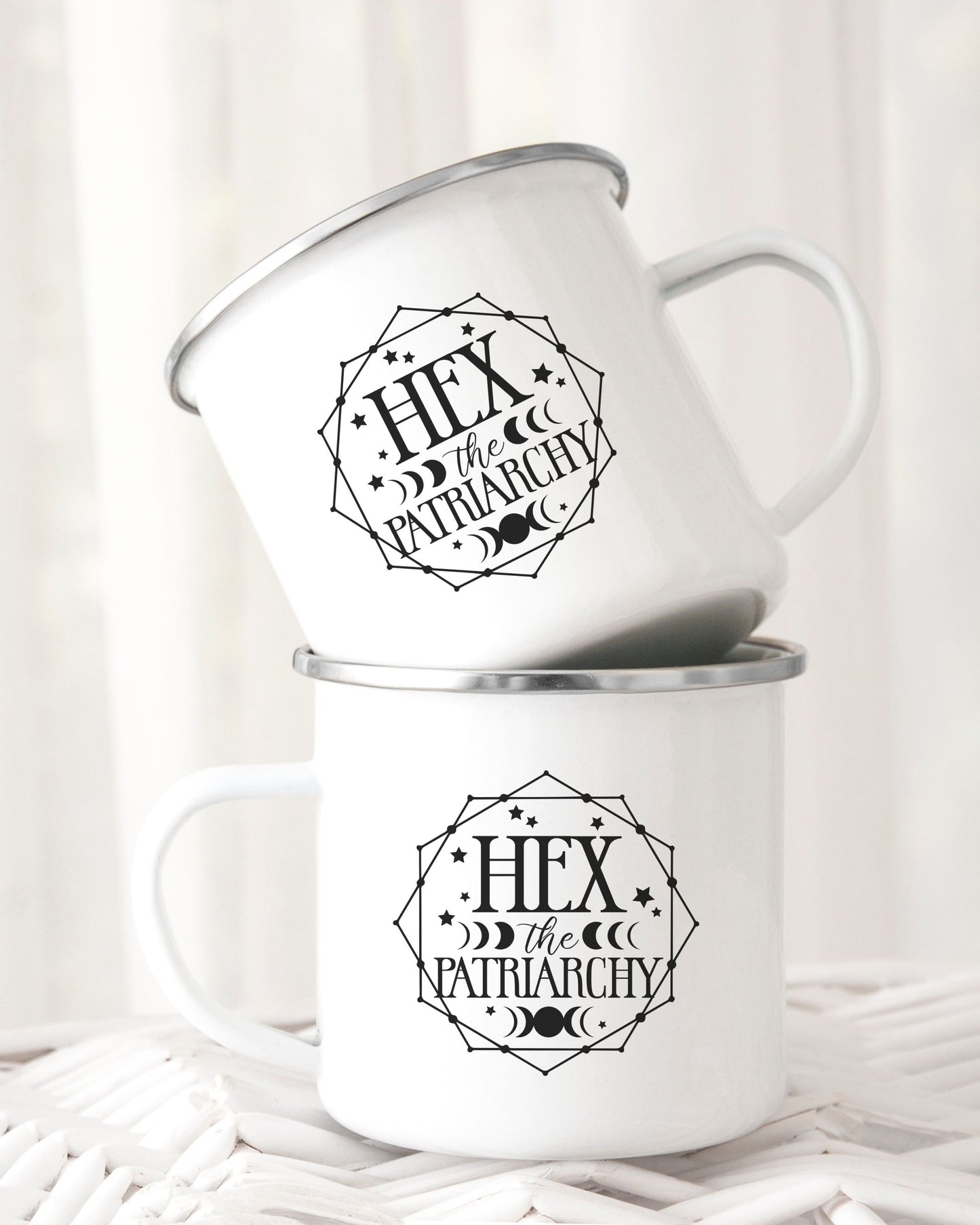 Two white mugs with 'Hex the Patriarchy' design on a white background