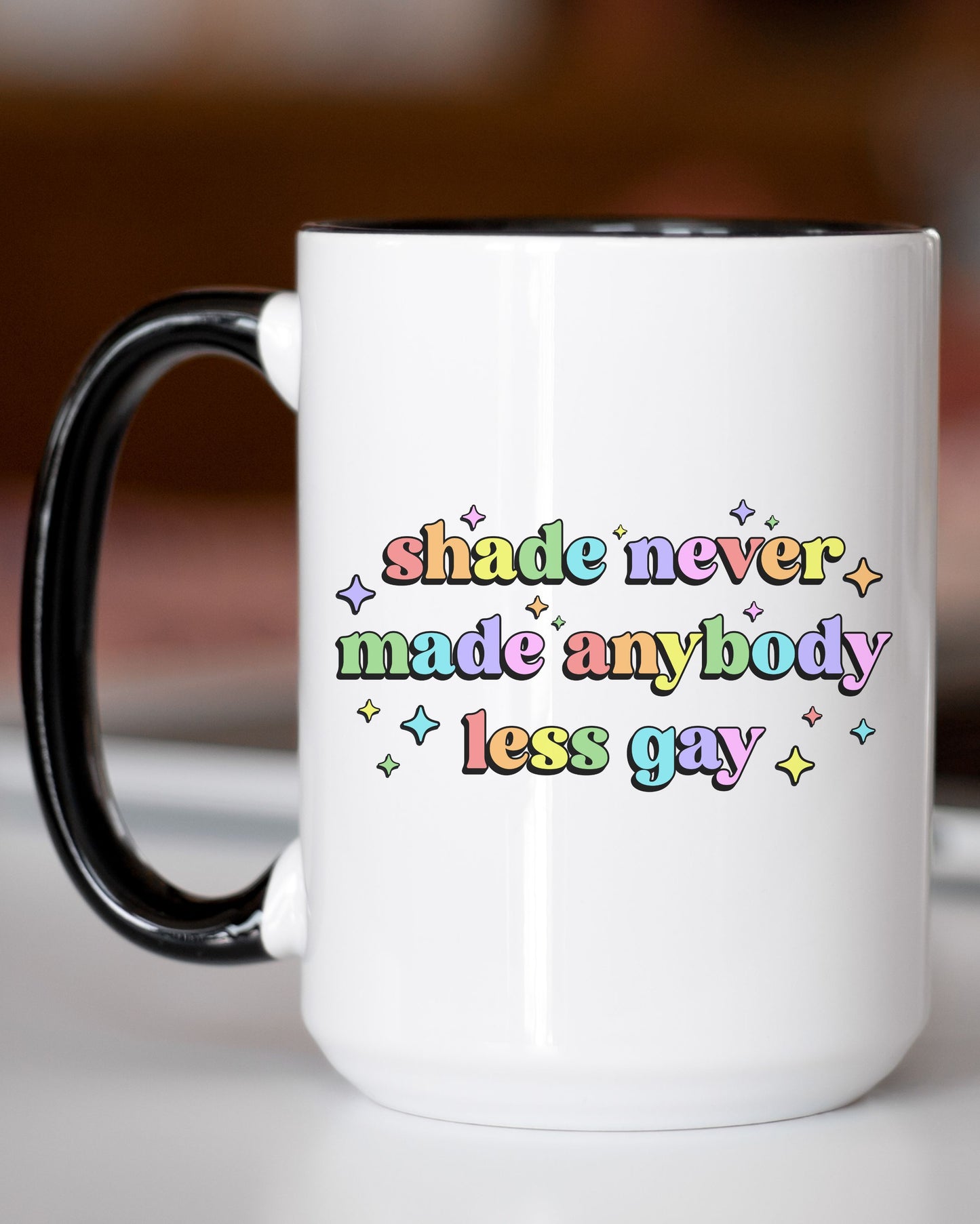 White mug with colorful text on a blurred background