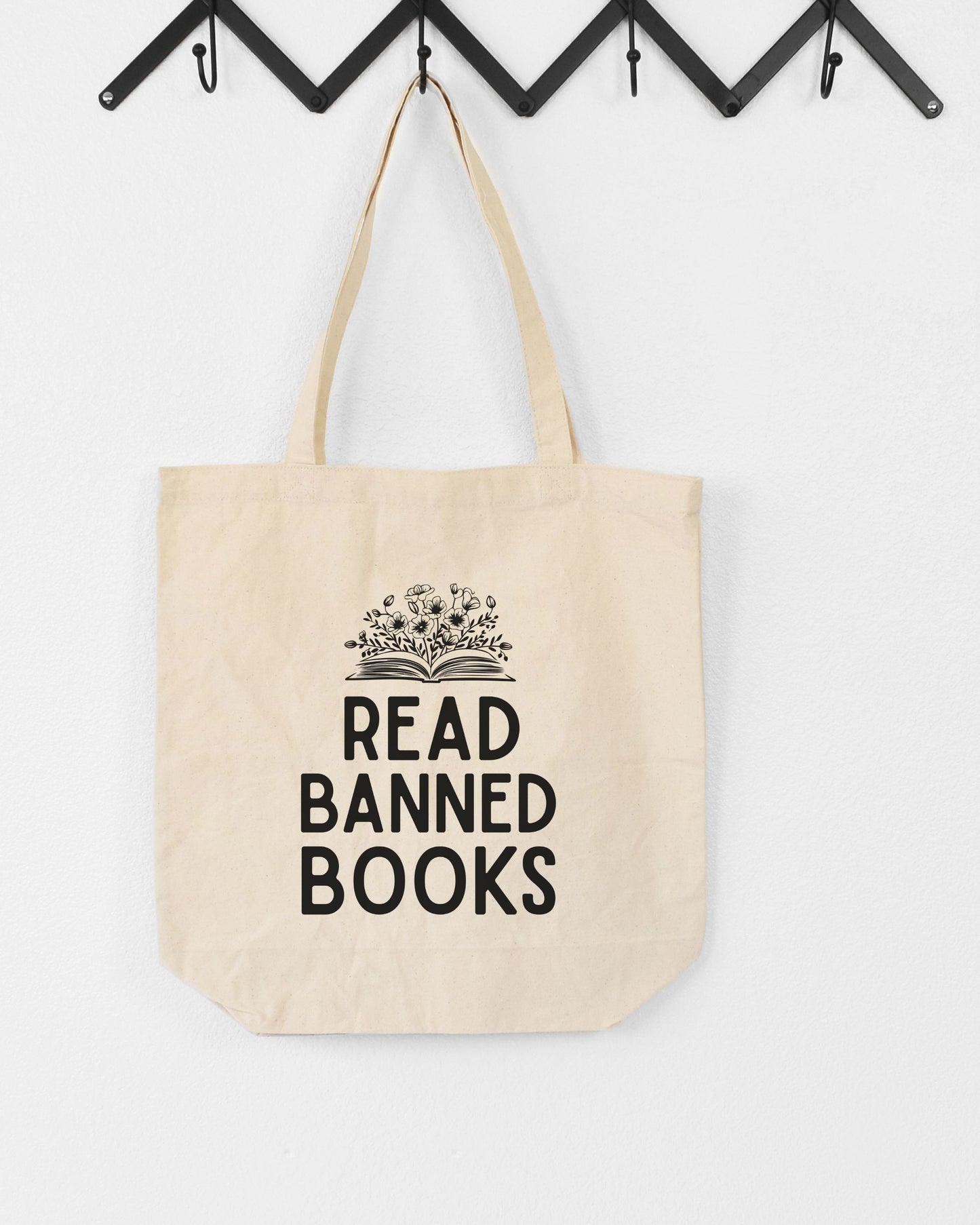 Beige tote bag with 'Read Banned Books' text on a white background