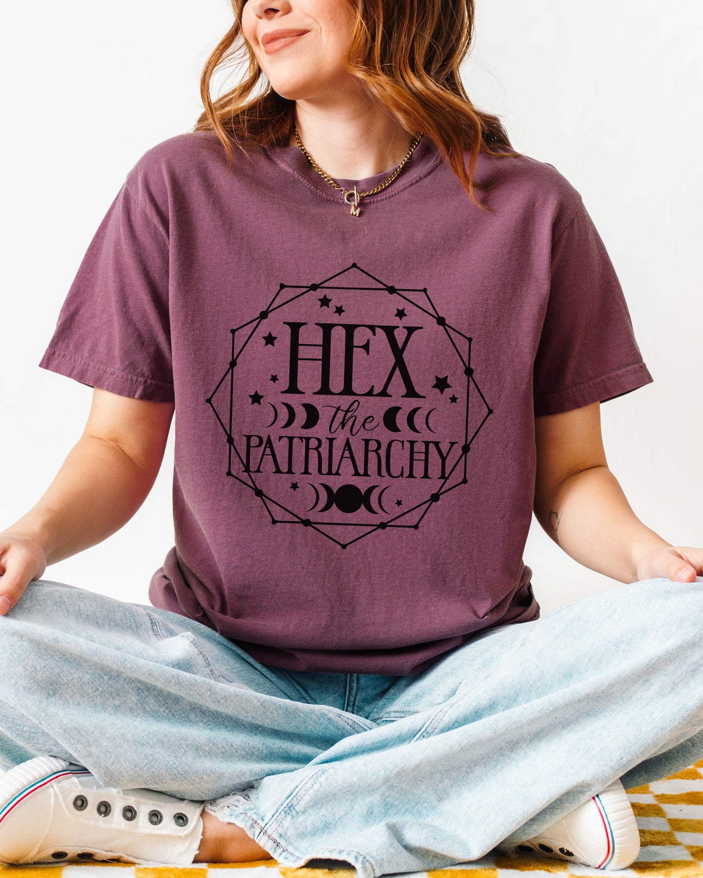 Person wearing a purple t-shirt with 'HEX the Patriarchy' design.