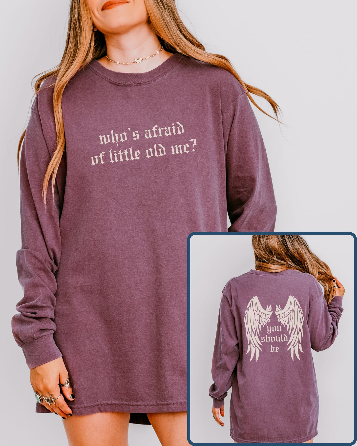 Purple long-sleeve shirt with text on front and back, worn by a person.