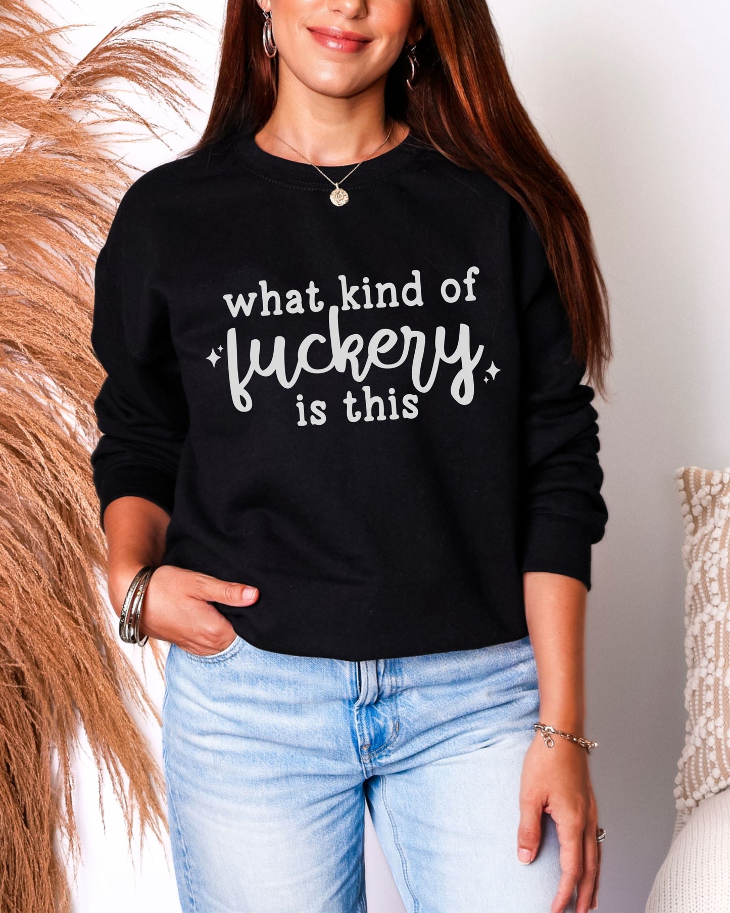 Person wearing a black sweatshirt with white text in a casual setting