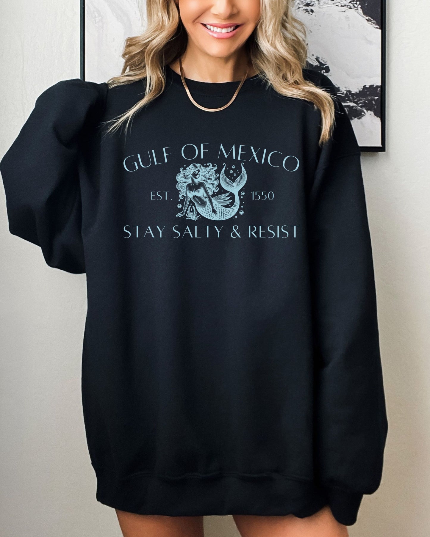 Person wearing a black sweatshirt with 'Gulf of Mexico' text and graphic