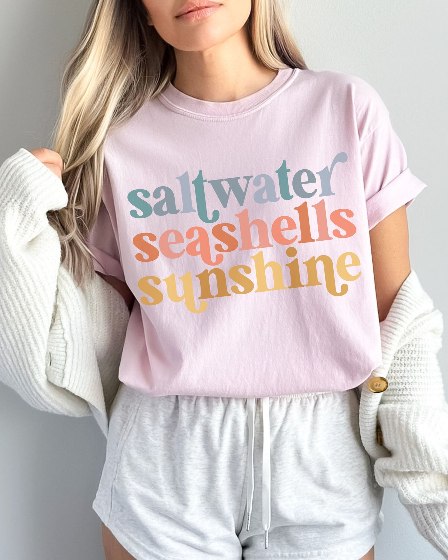 woman wearing beach vibes shirt with saltwater seashells sunshine design
