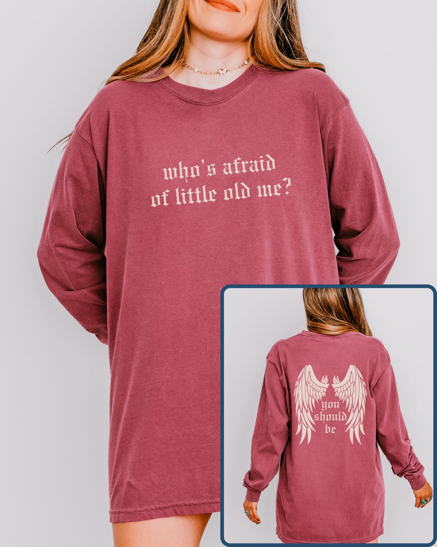 Maroon long-sleeve shirt with text on a plain background
