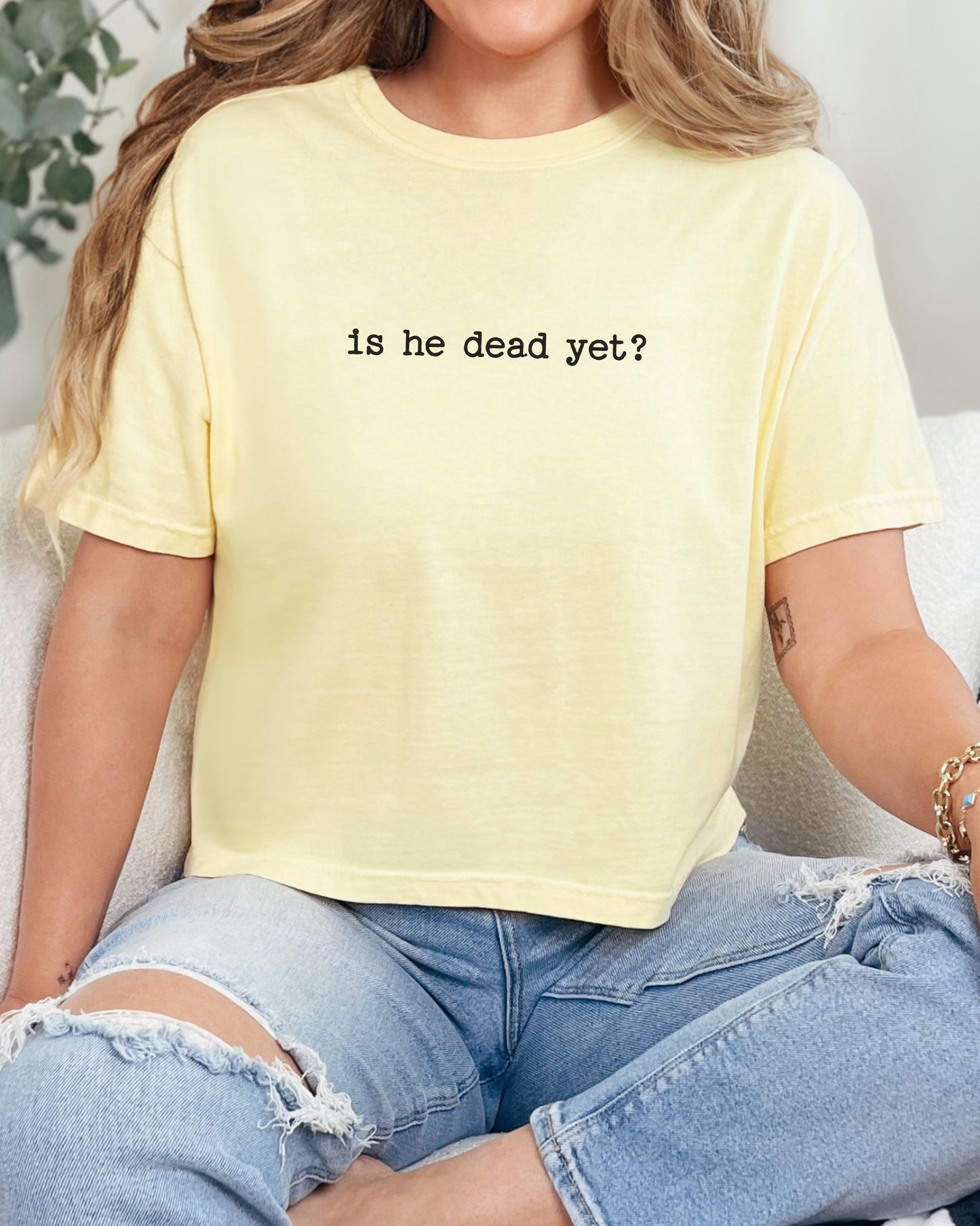 woman wearing is he dead yet dark humor crop top