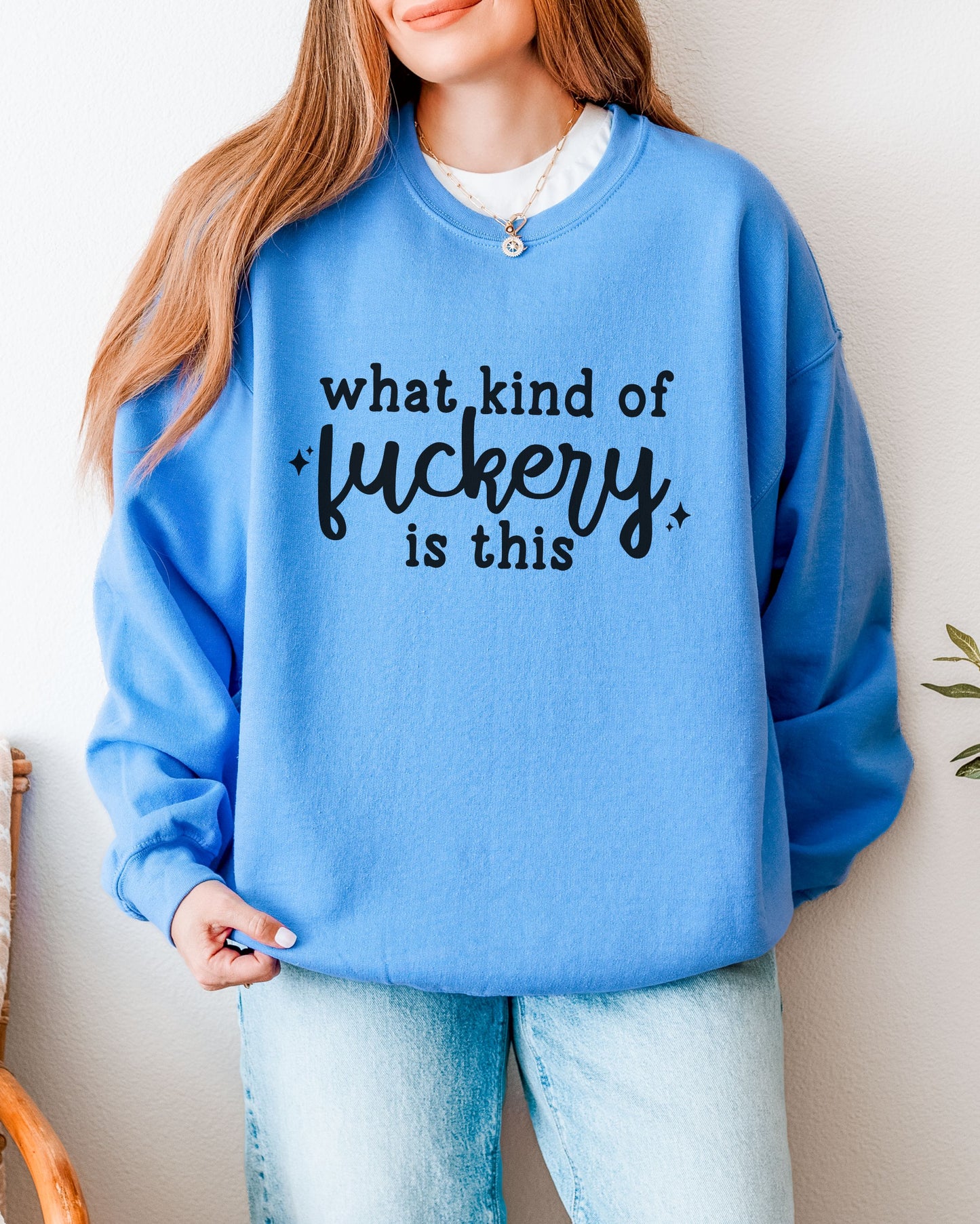 Person wearing a blue sweatshirt with text design against a neutral background