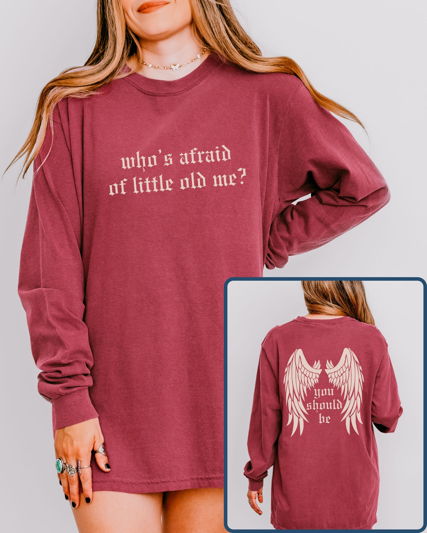 Maroon long-sleeve shirt with text and wings graphic worn by a person on a plain background