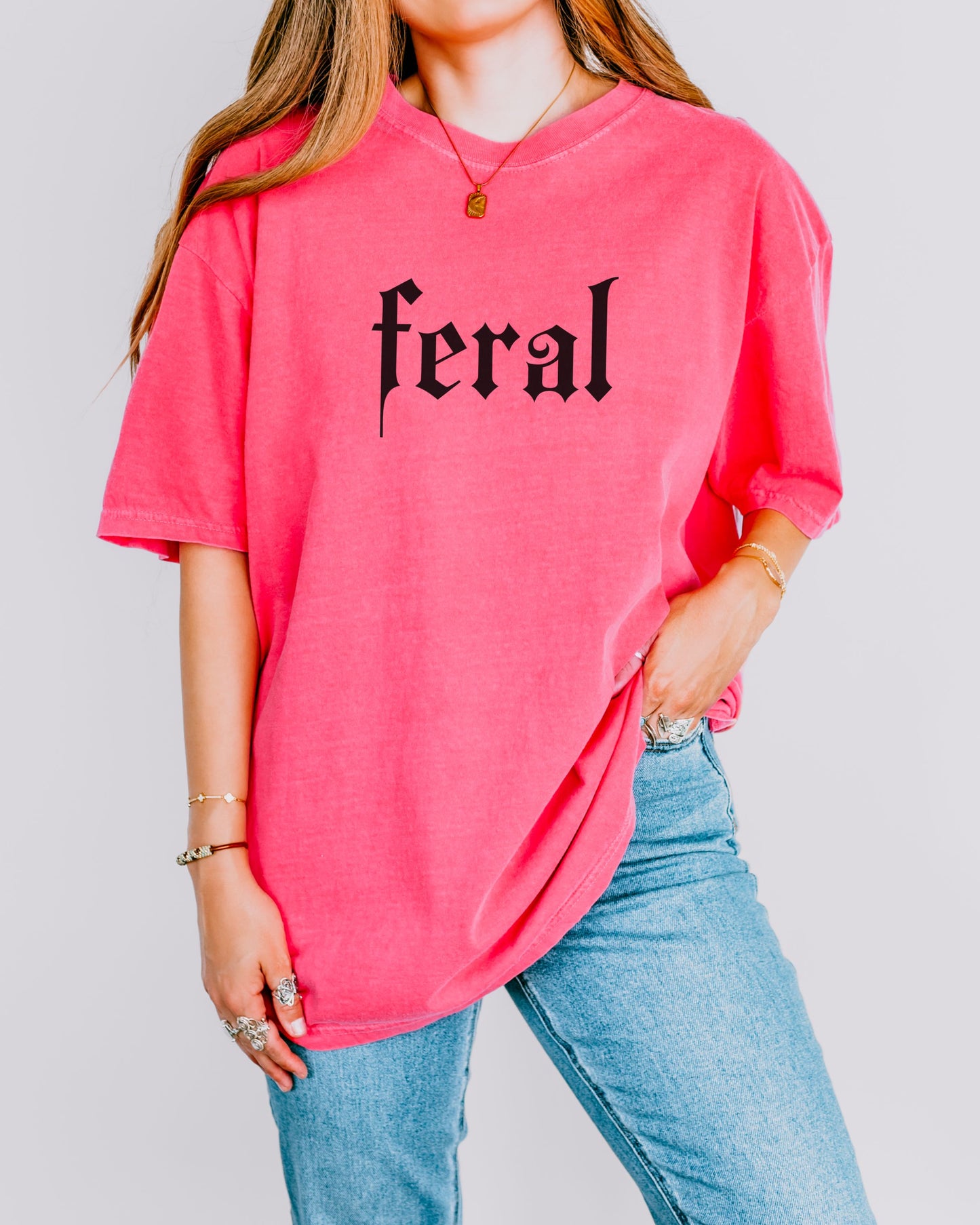 grunge aesthetic feral t-shirt in black font worn by model, in color crunchberry