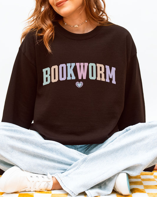 Person wearing a dark brown sweatshirt with 'BOOKWORM' in colorful letters on a white background