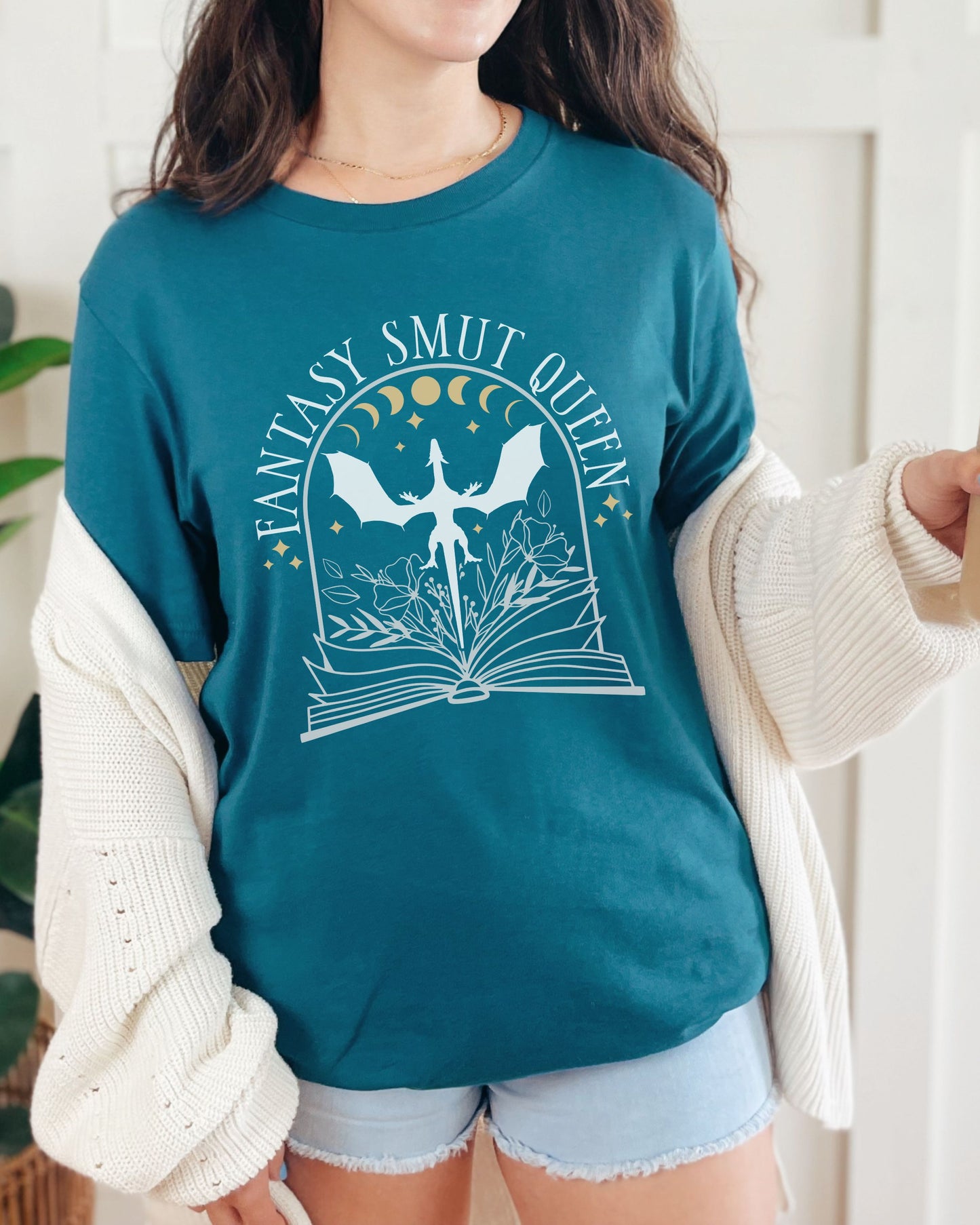 Person wearing a teal sweatshirt with 'Fantasy Smut Queen' graphic design.