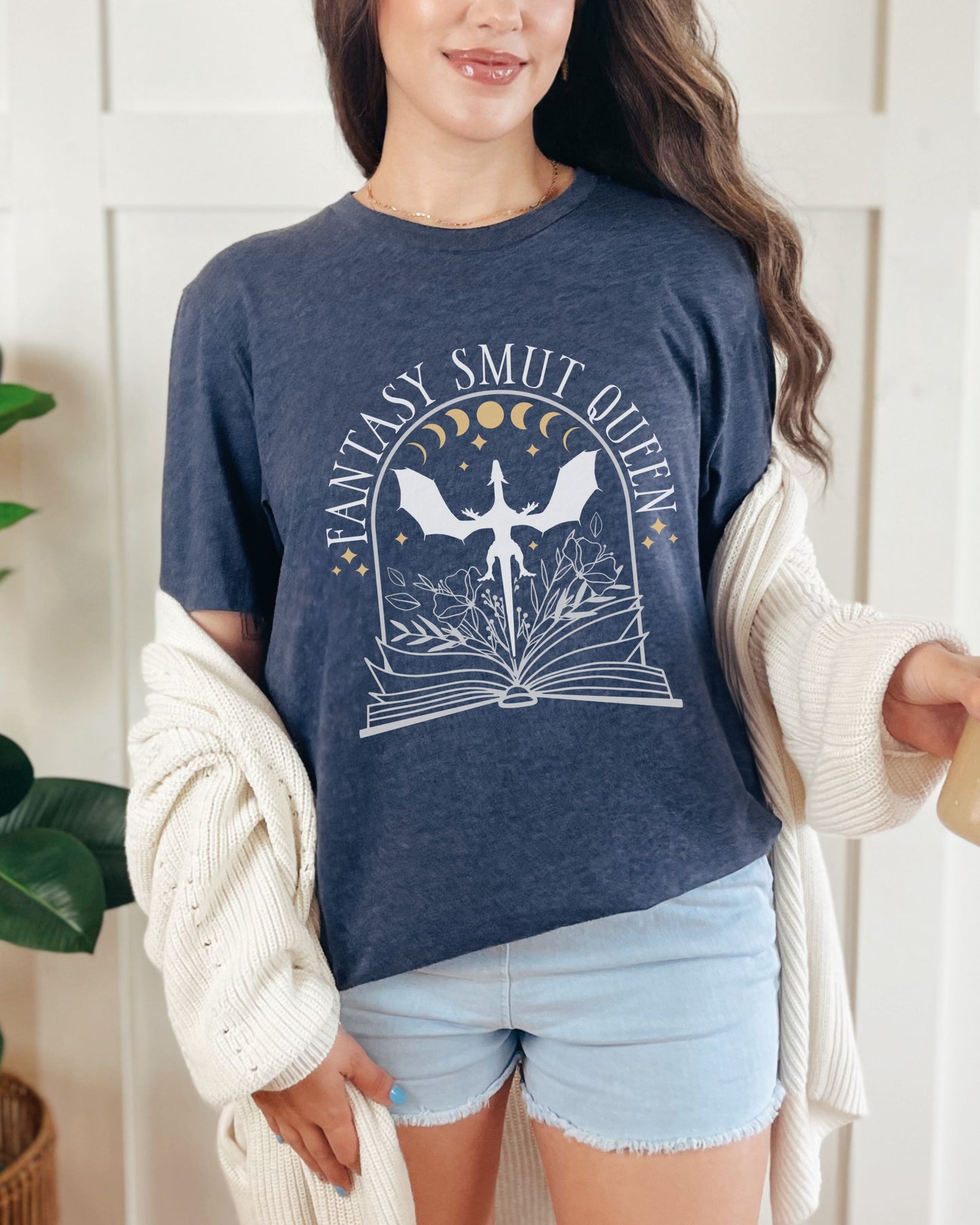 Woman wearing a navy blue t-shirt with 'Fantasy Smut Queen' graphic design.