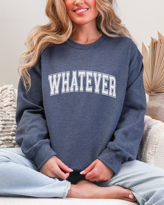 Person wearing a navy sweatshirt with 'WHATEVER' text, sitting on a couch.