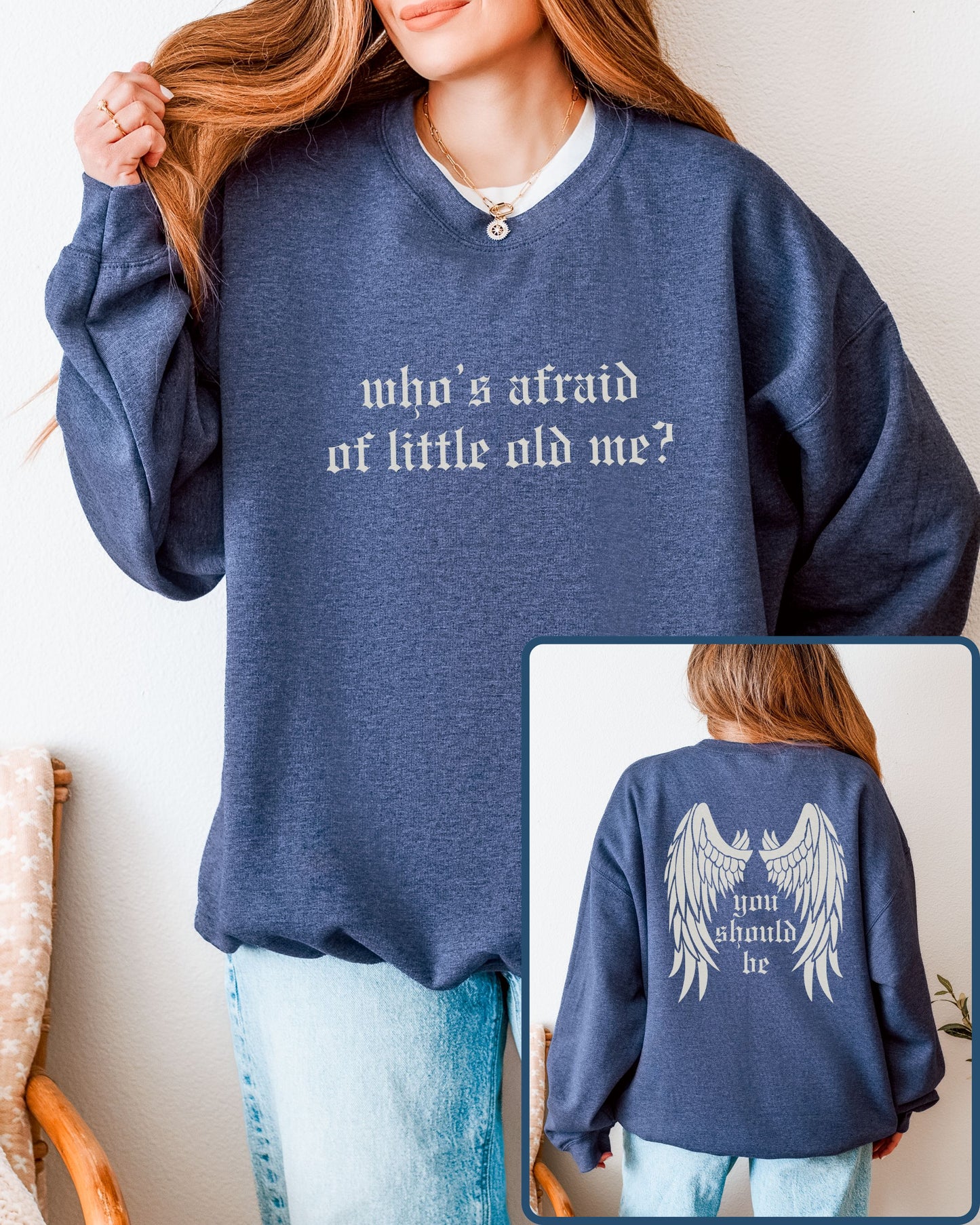 Person wearing a blue sweatshirt with text and an angel wings design on the back.