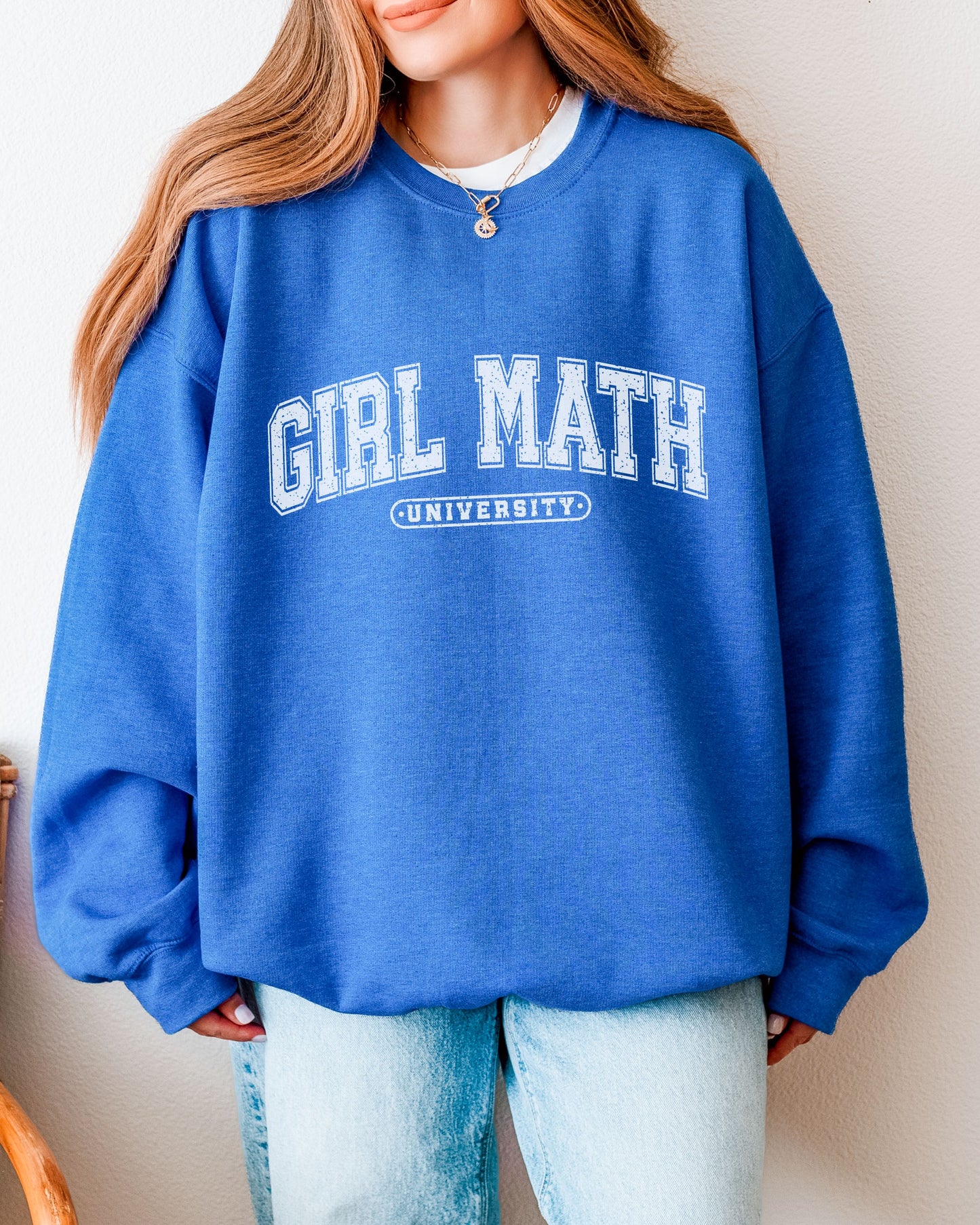 Person wearing a blue sweatshirt with 'Girl Math University' text.