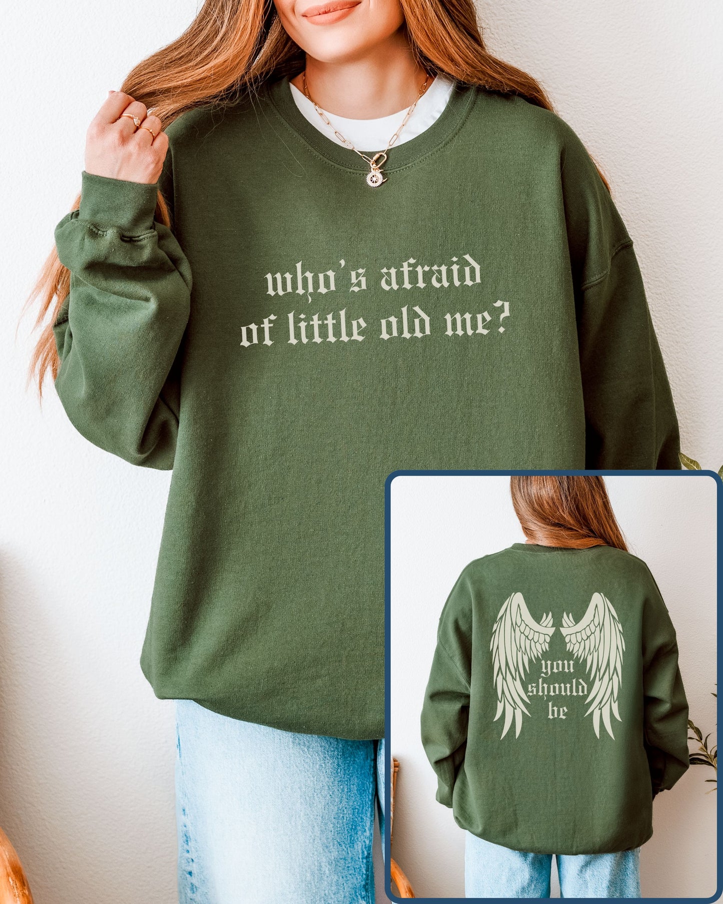 Green sweatshirt with text 'who's afraid of little old me?' on front, worn by a person, with inset showing back text 'you should be'.