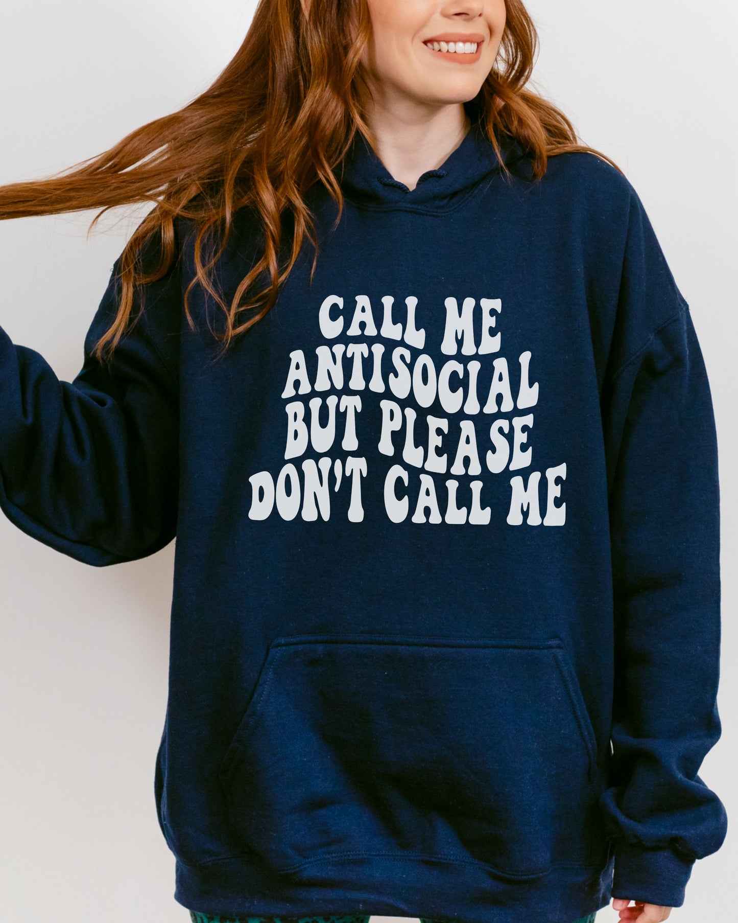 Person wearing a navy hoodie with white text on a plain background