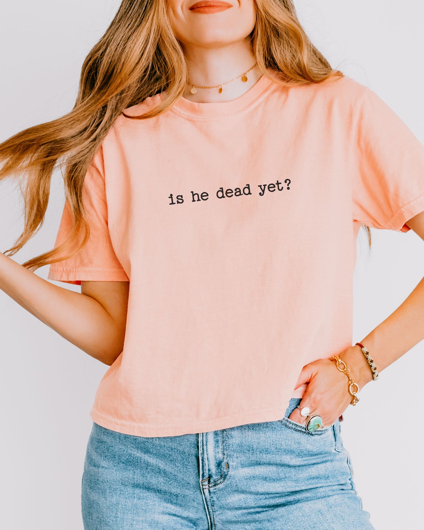 woman wearing is he dead yet dark humor crop top