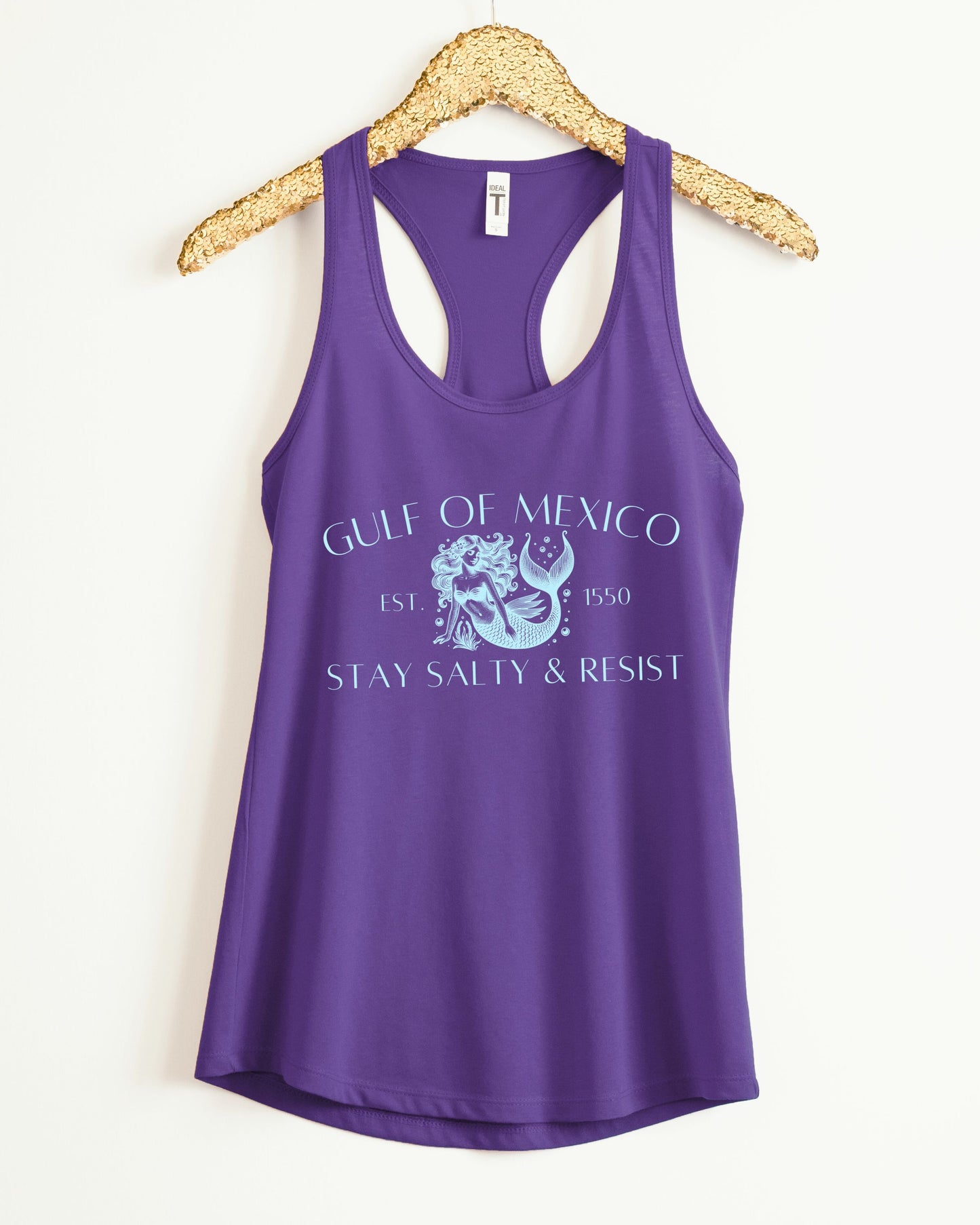 Purple tank top with graphic design and text on a hanger against a white background