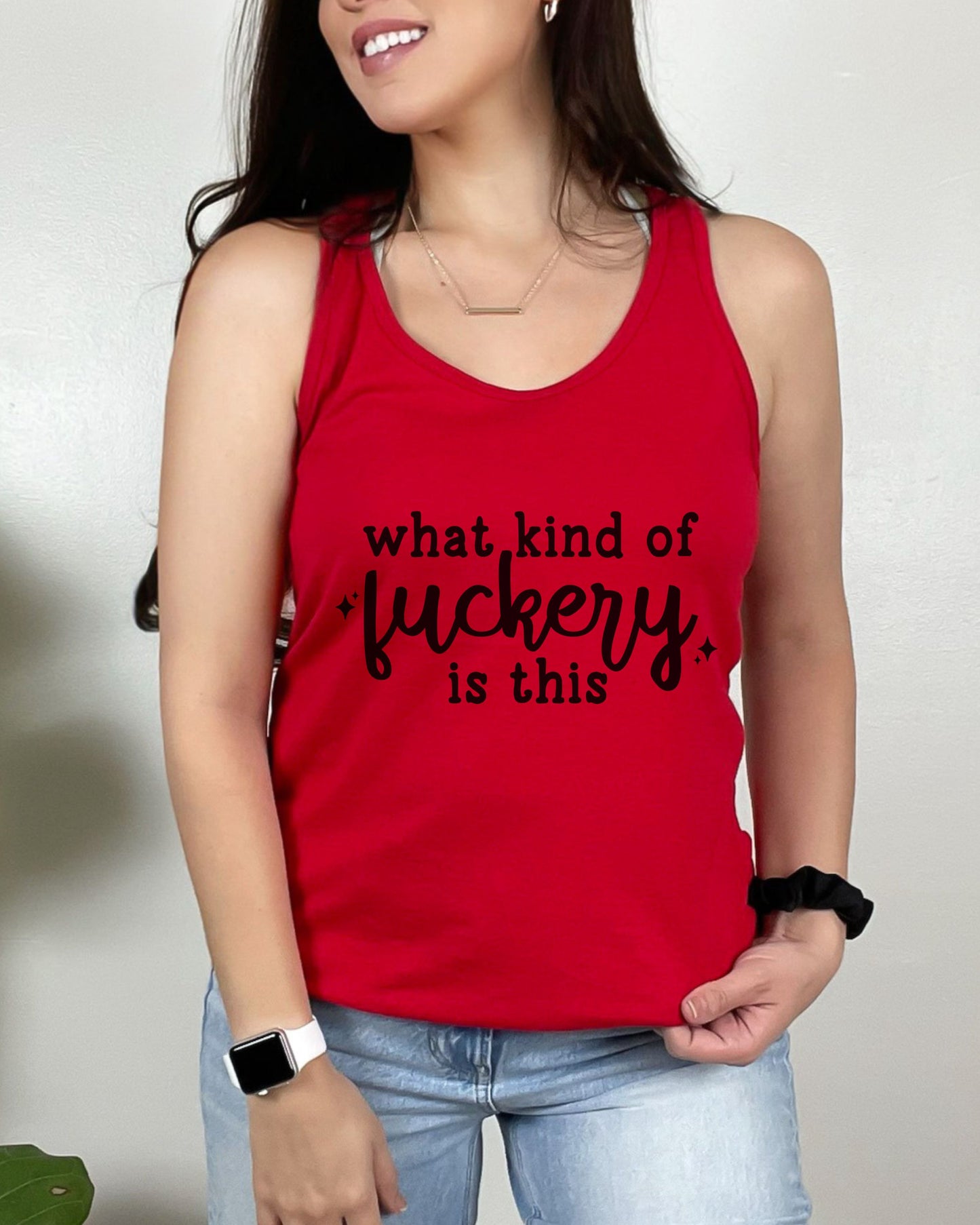 Person wearing a red tank top with black text against a neutral background