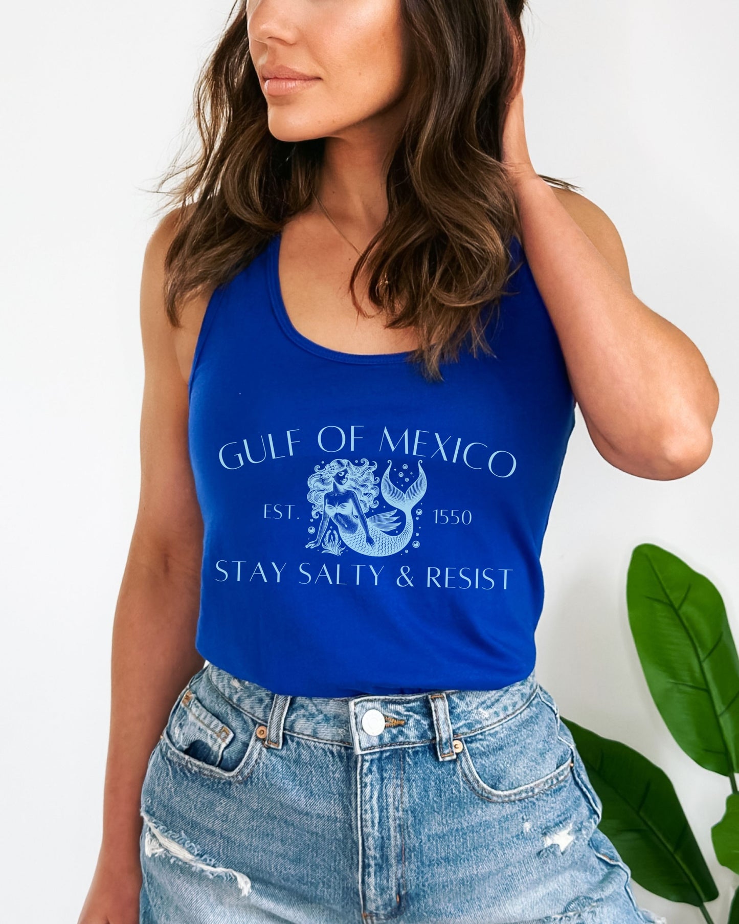 Woman wearing a blue tank top with 'Gulf of Mexico' text and design.