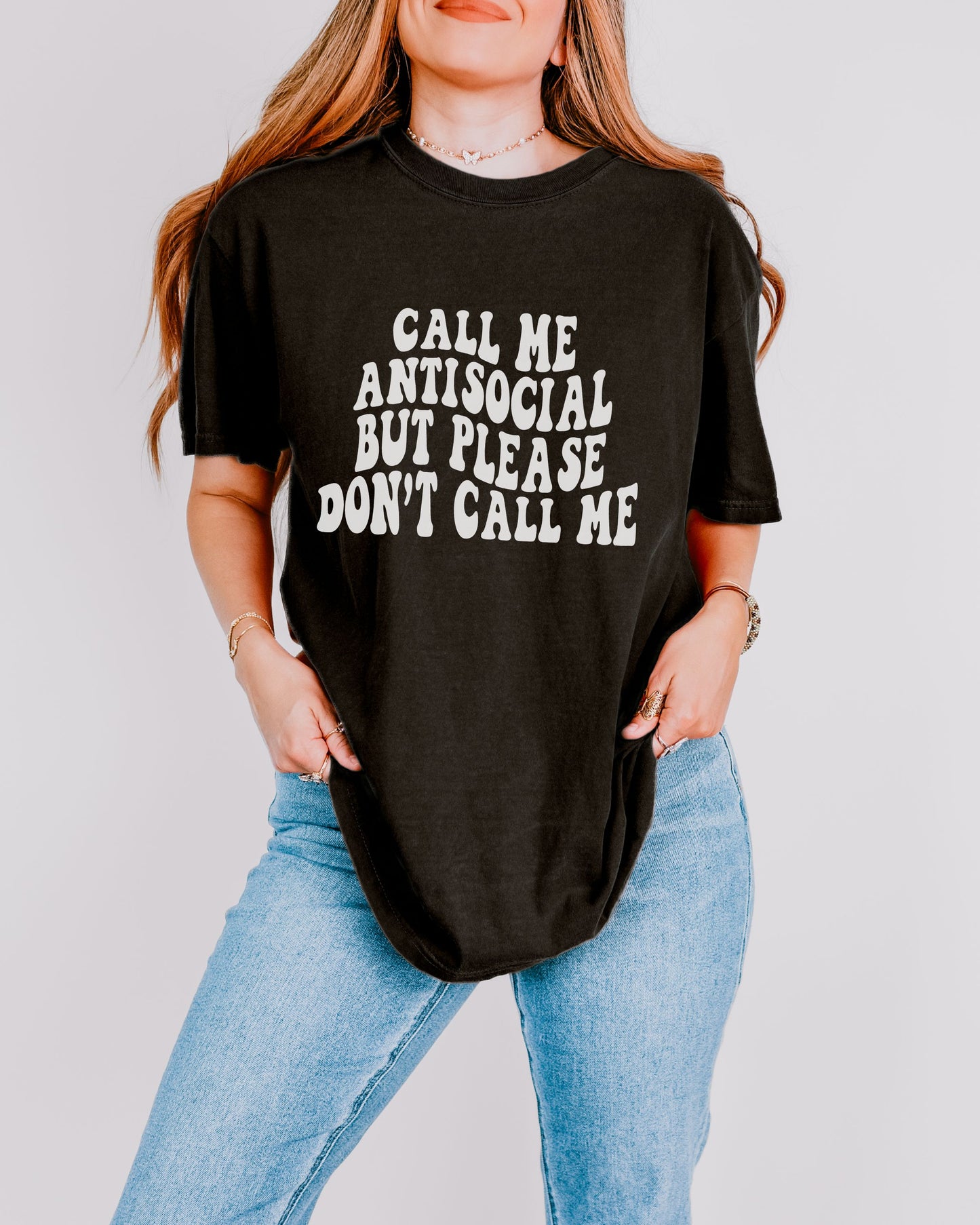 Person wearing a black t-shirt with white text on a plain background