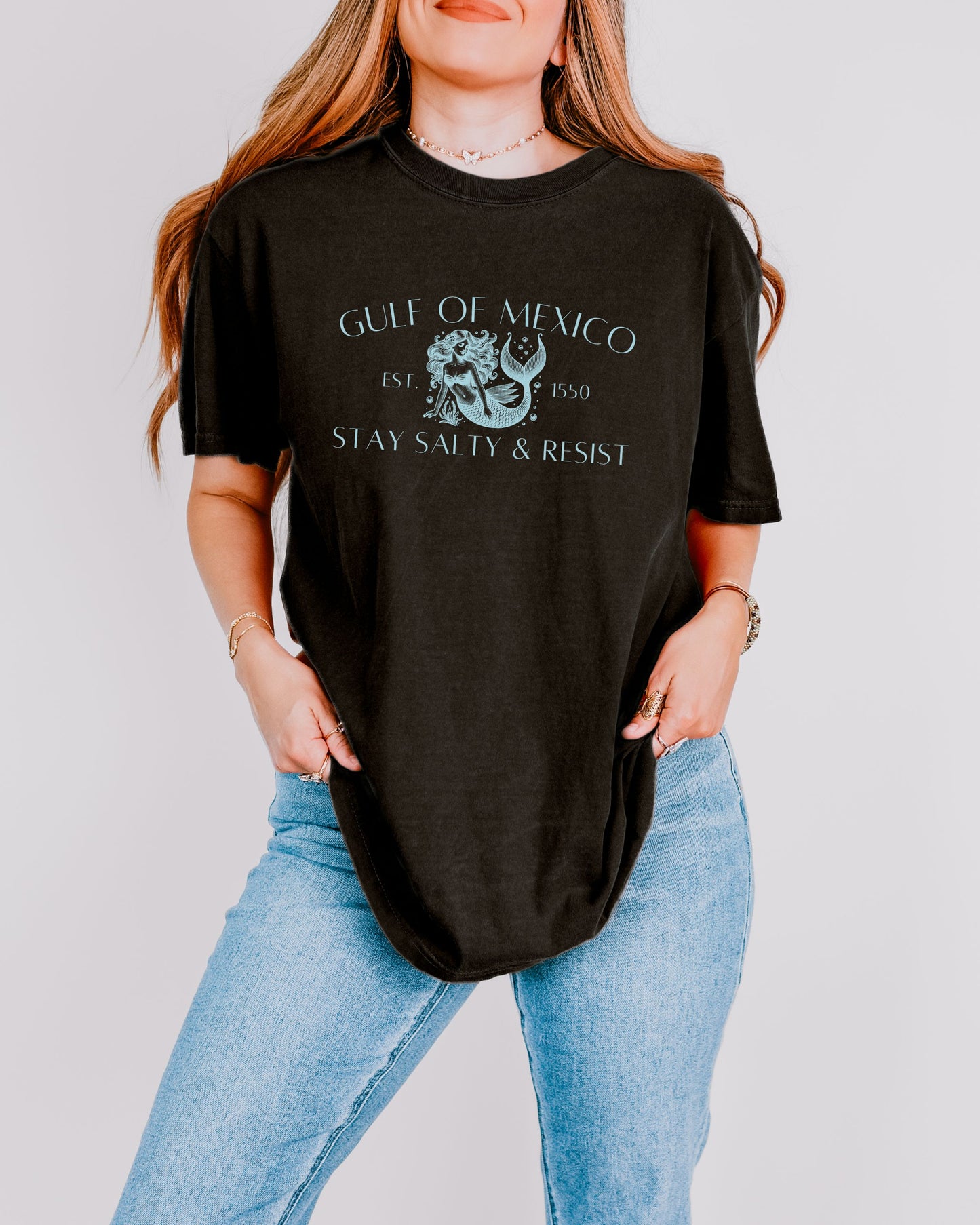 Person wearing a black t-shirt with Gulf of Mexico design and text.