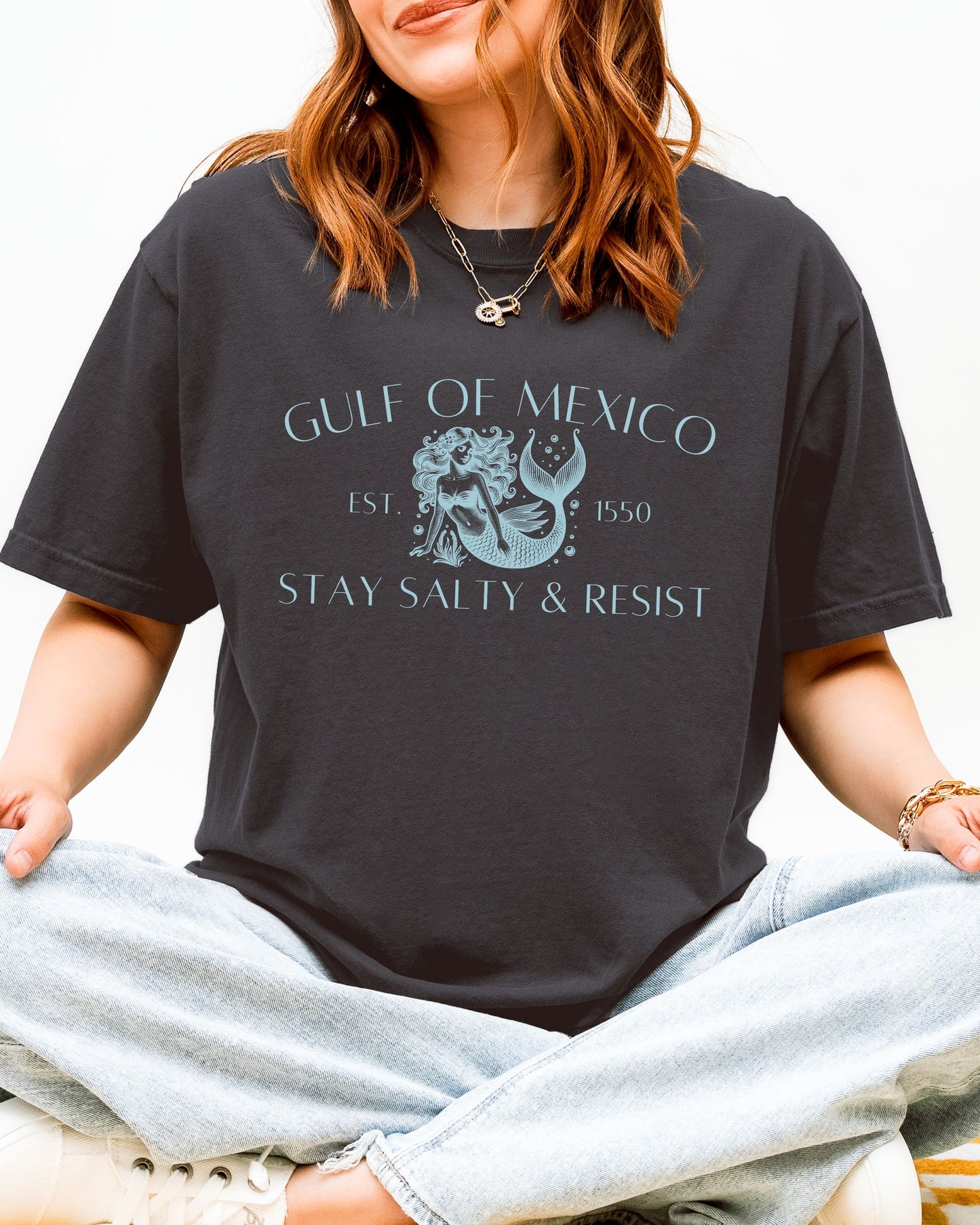 Person wearing a black t-shirt with Gulf of Mexico design and text