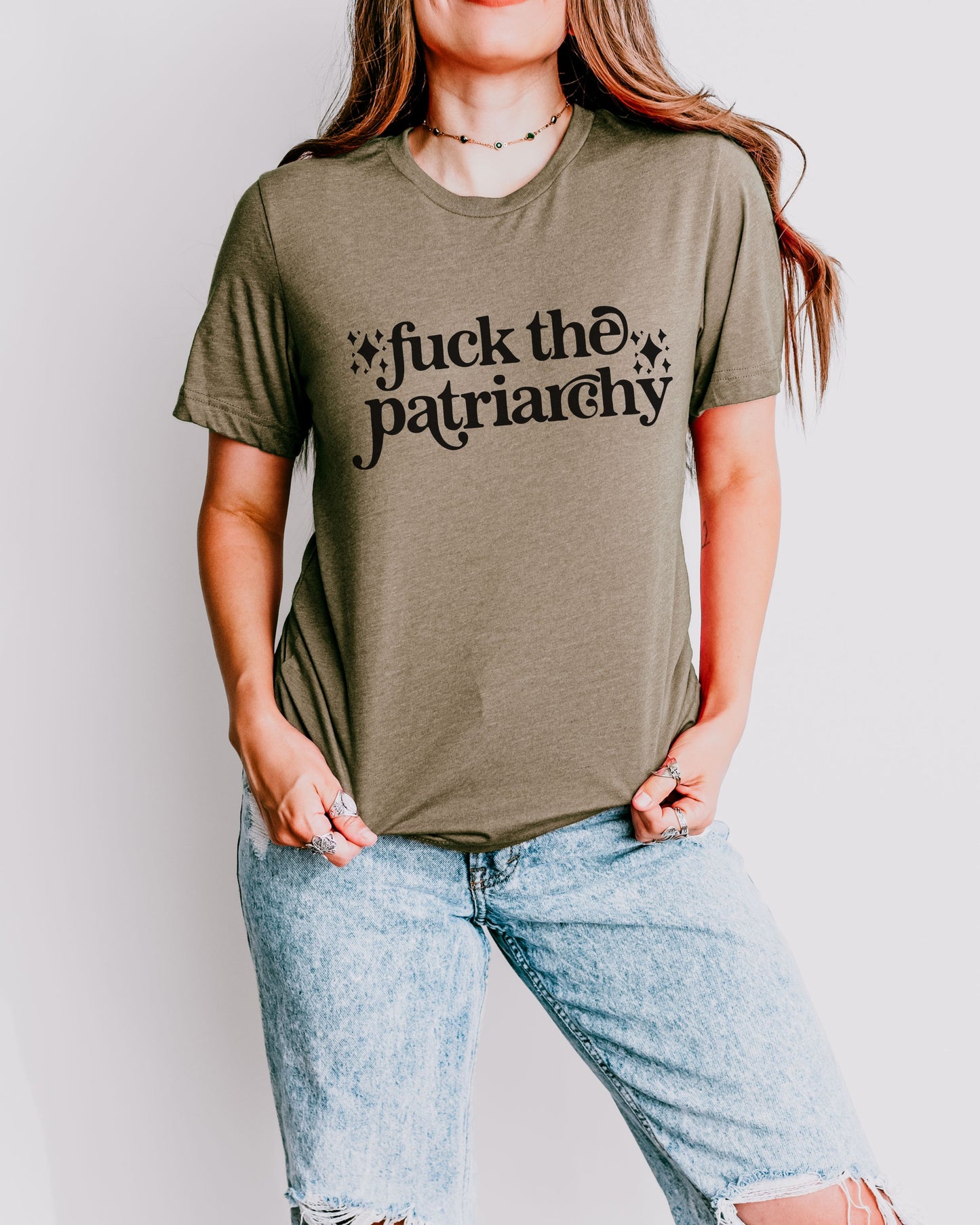 woman wearing a heather olive fuck the patriarchy shirt, feminist graphic tee