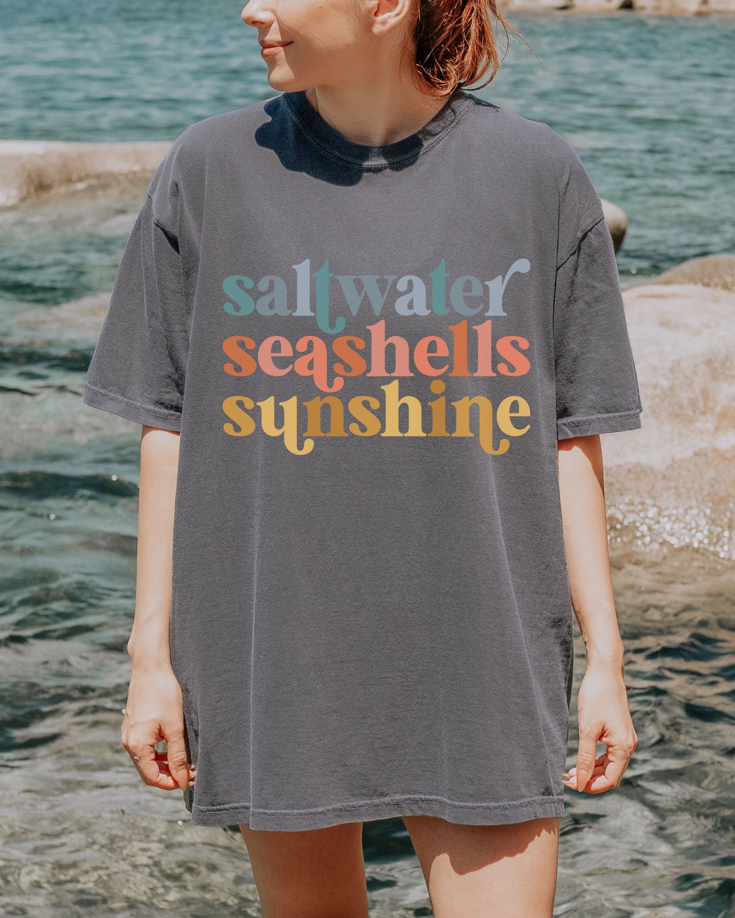 woman wearing beach vibes shirt with saltwater seashells sunshine design