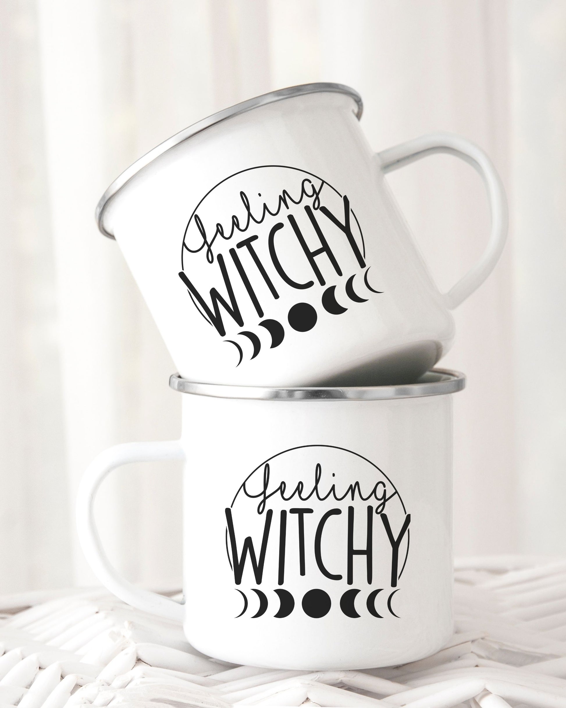 Two white mugs with 'Feeling Witchy' text on a white background