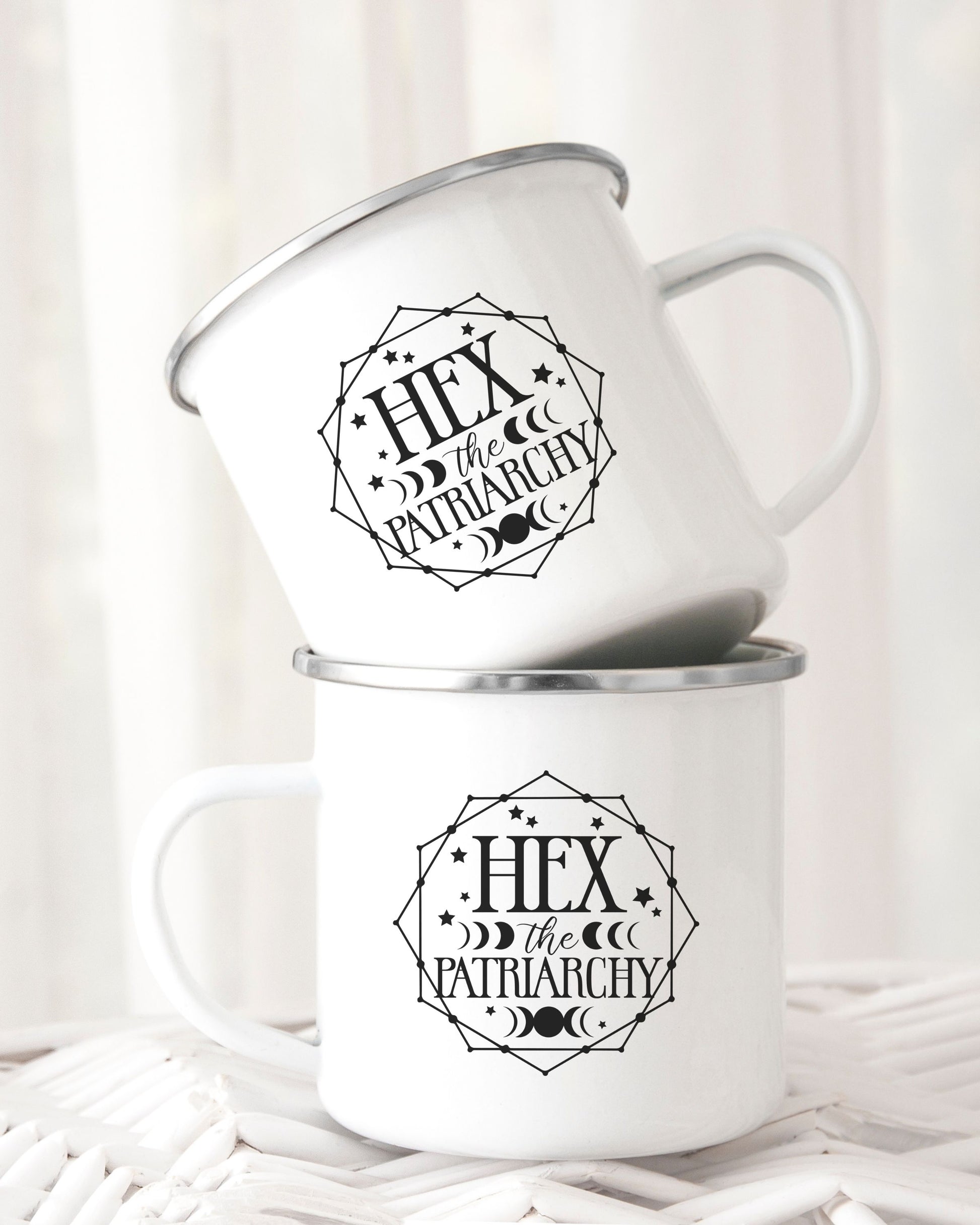Two white mugs with 'Hex the Patriarchy' design on a white background