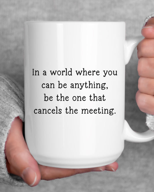 White mug with humorous text held by a person against a gray background