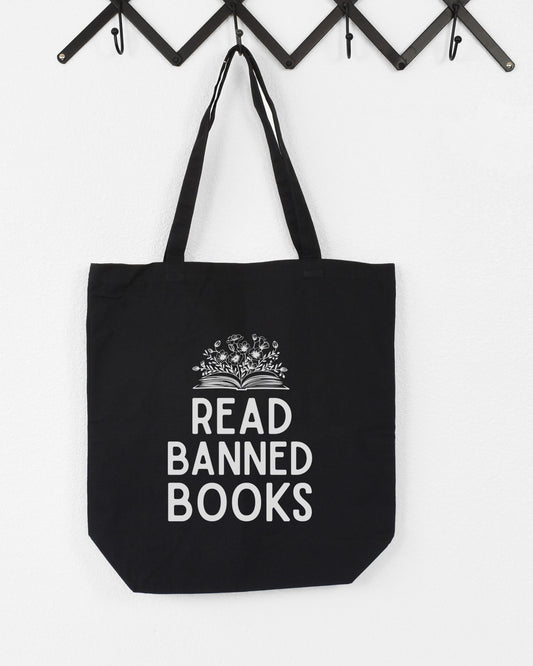Black tote bag with 'Read Banned Books' text on a white background