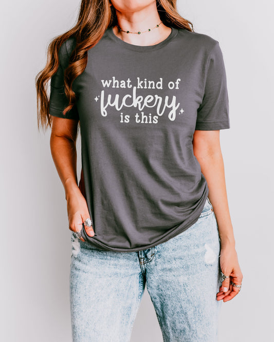 Person wearing a dark gray t-shirt with text on a plain background