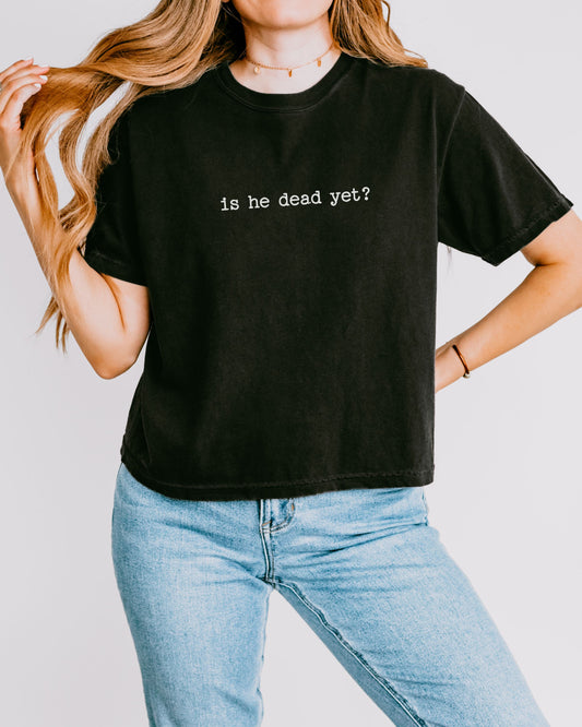 woman wearing is he dead yet dark humor crop top
