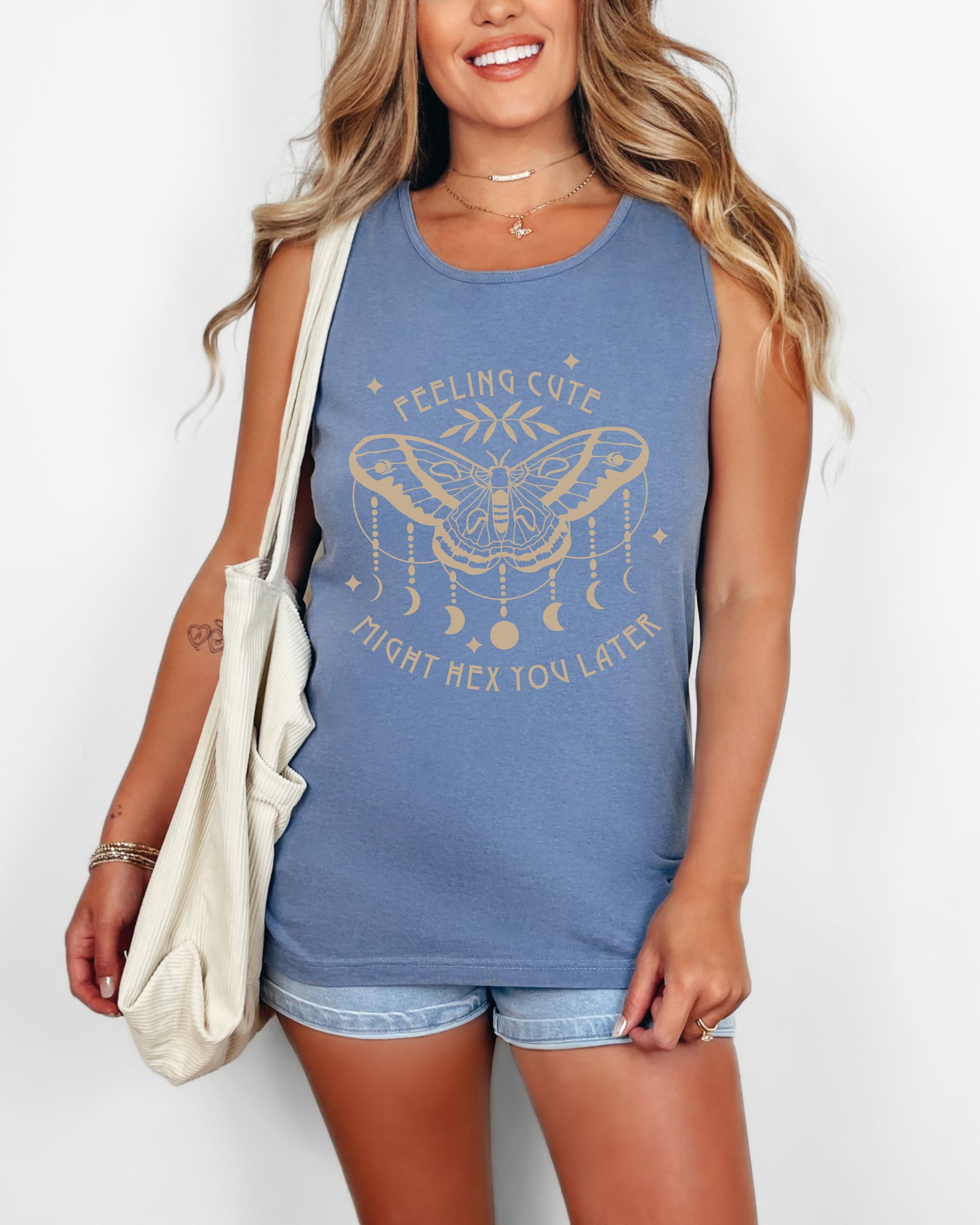 Woman wearing a blue tank top with a graphic design and text.