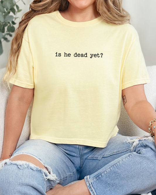 woman wearing is he dead yet dark humor crop top
