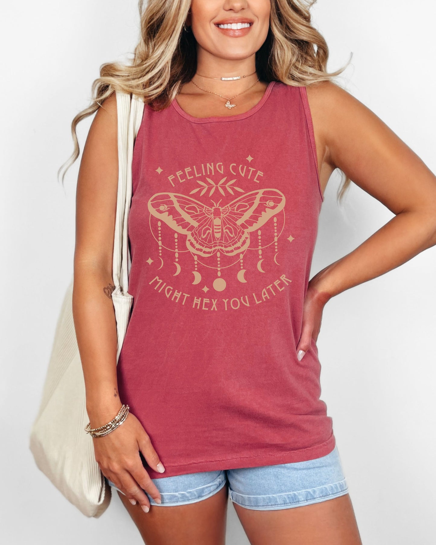 Woman wearing a red tank top with a graphic design and text.