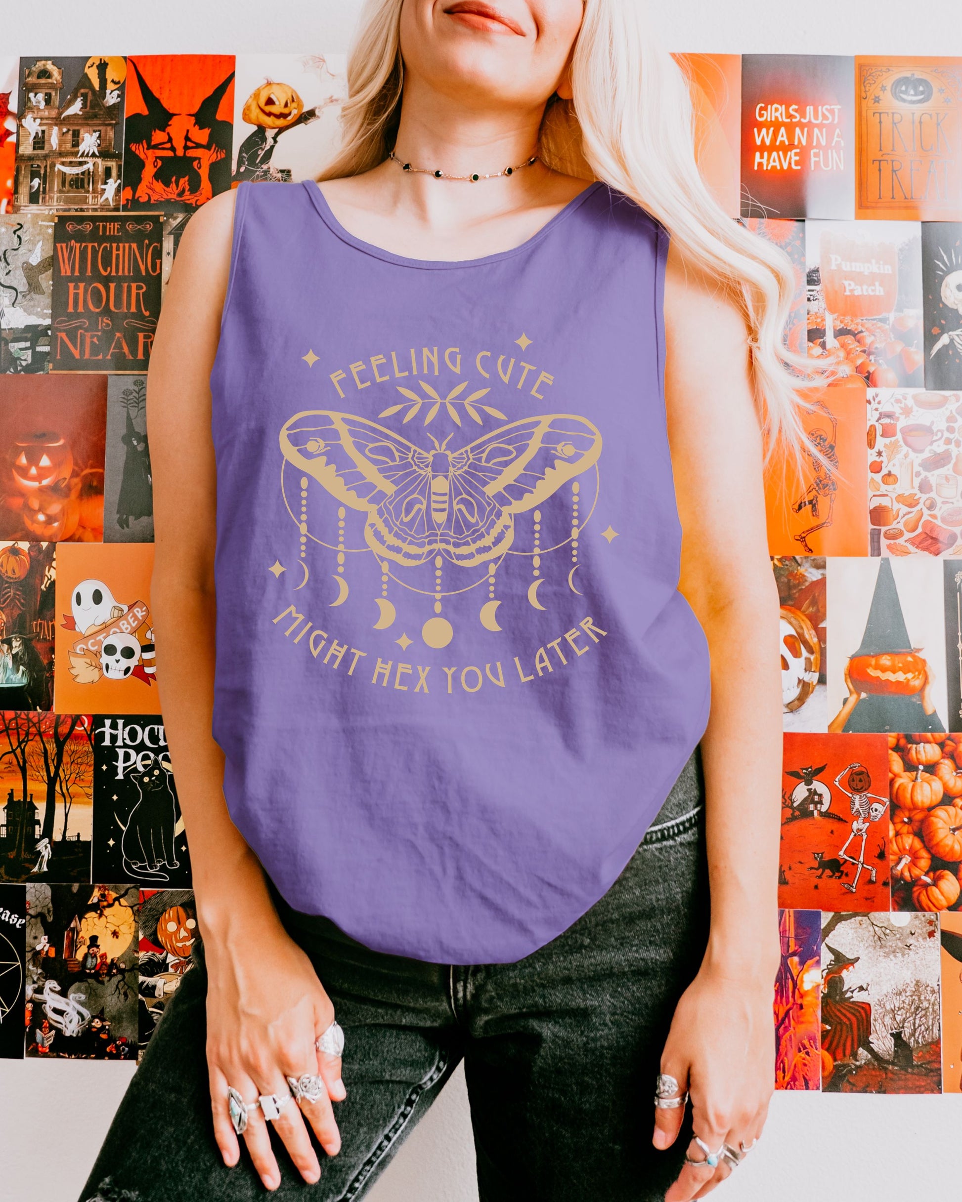 Person wearing a purple tank top with a graphic design in front of a Halloween-themed collage.
