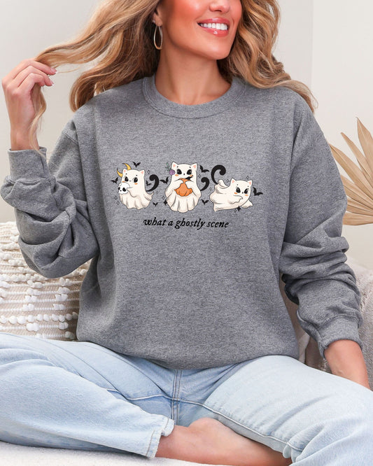 Person wearing a gray sweatshirt with ghost designs and text.