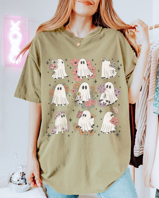 Person wearing a khaki t-shirt with ghost and flower pattern