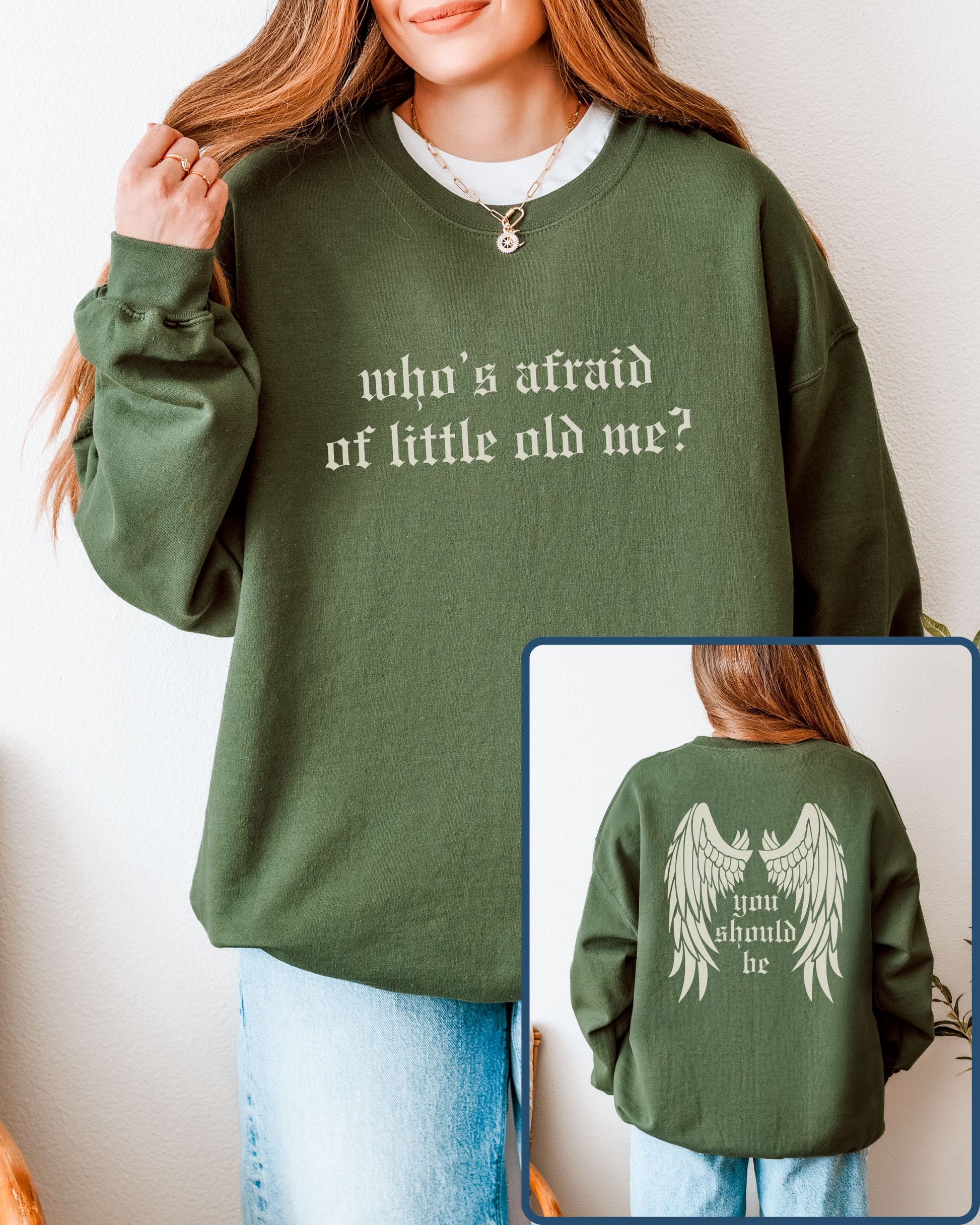 Green sweatshirt with text 'who's afraid of little old me?' on front, worn by a person, with inset showing back text 'you should be'.