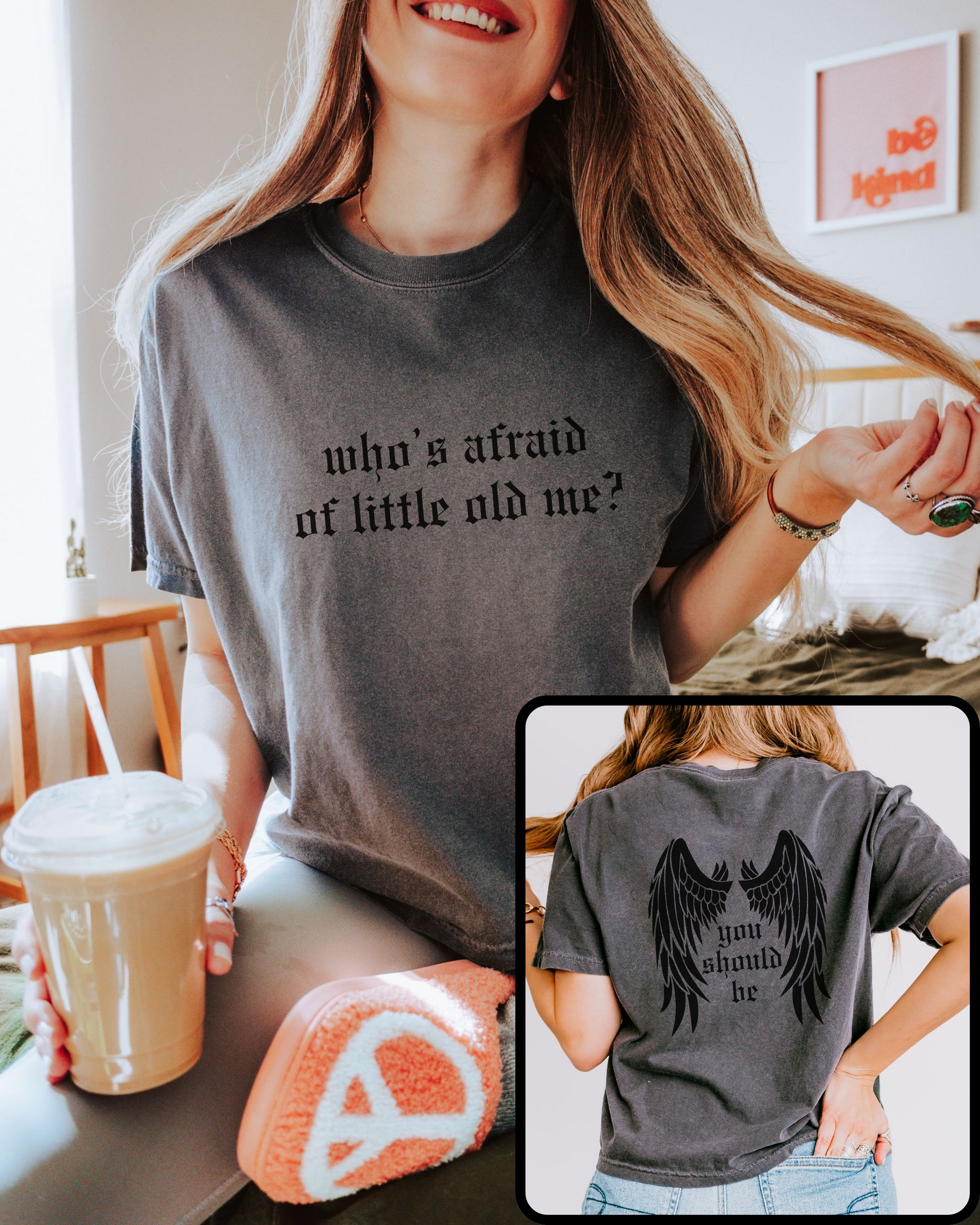 woman wearing comfort colors crop top in pepper gray with who’s afraid of little old me text on front and wings with you should be on back

