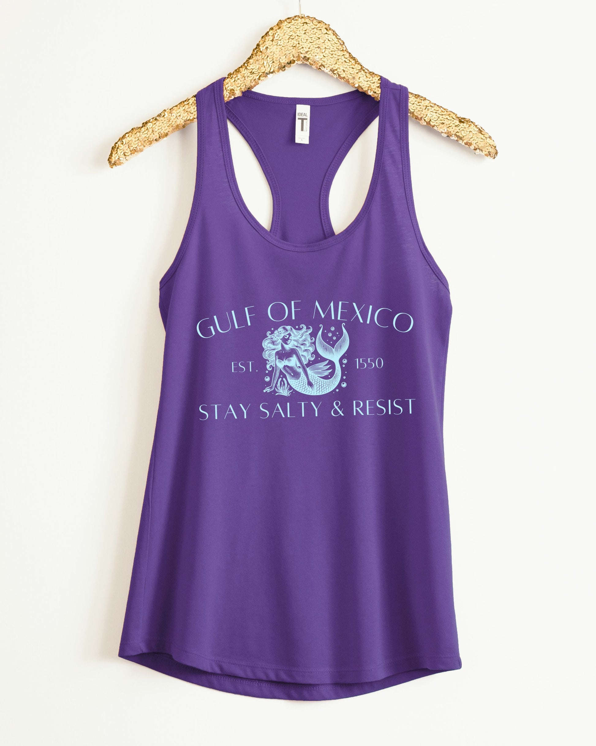Purple tank top with graphic design and text on a hanger against a white background