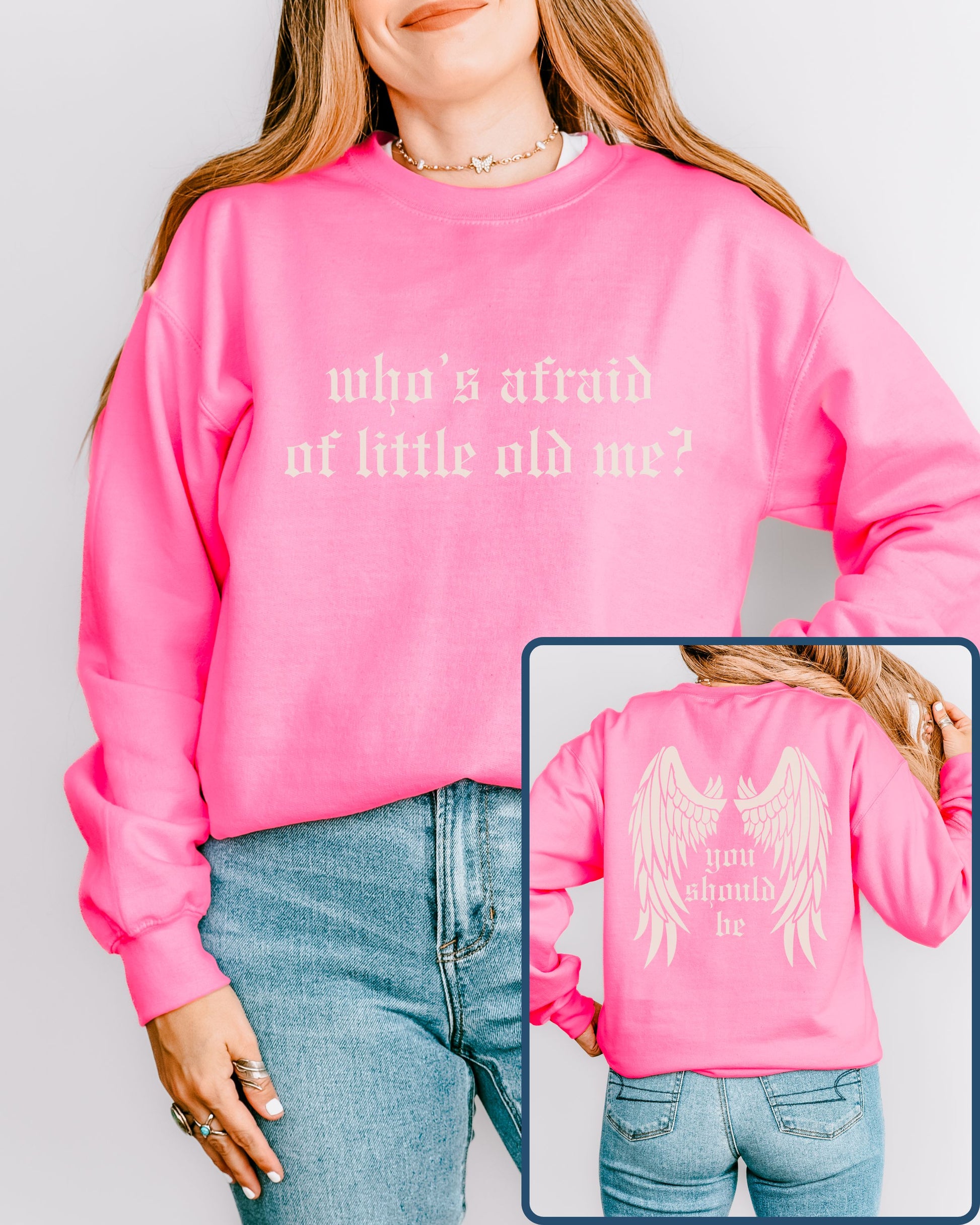 Person wearing a pink sweatshirt with text and an angel wings design on the back, against a plain background.