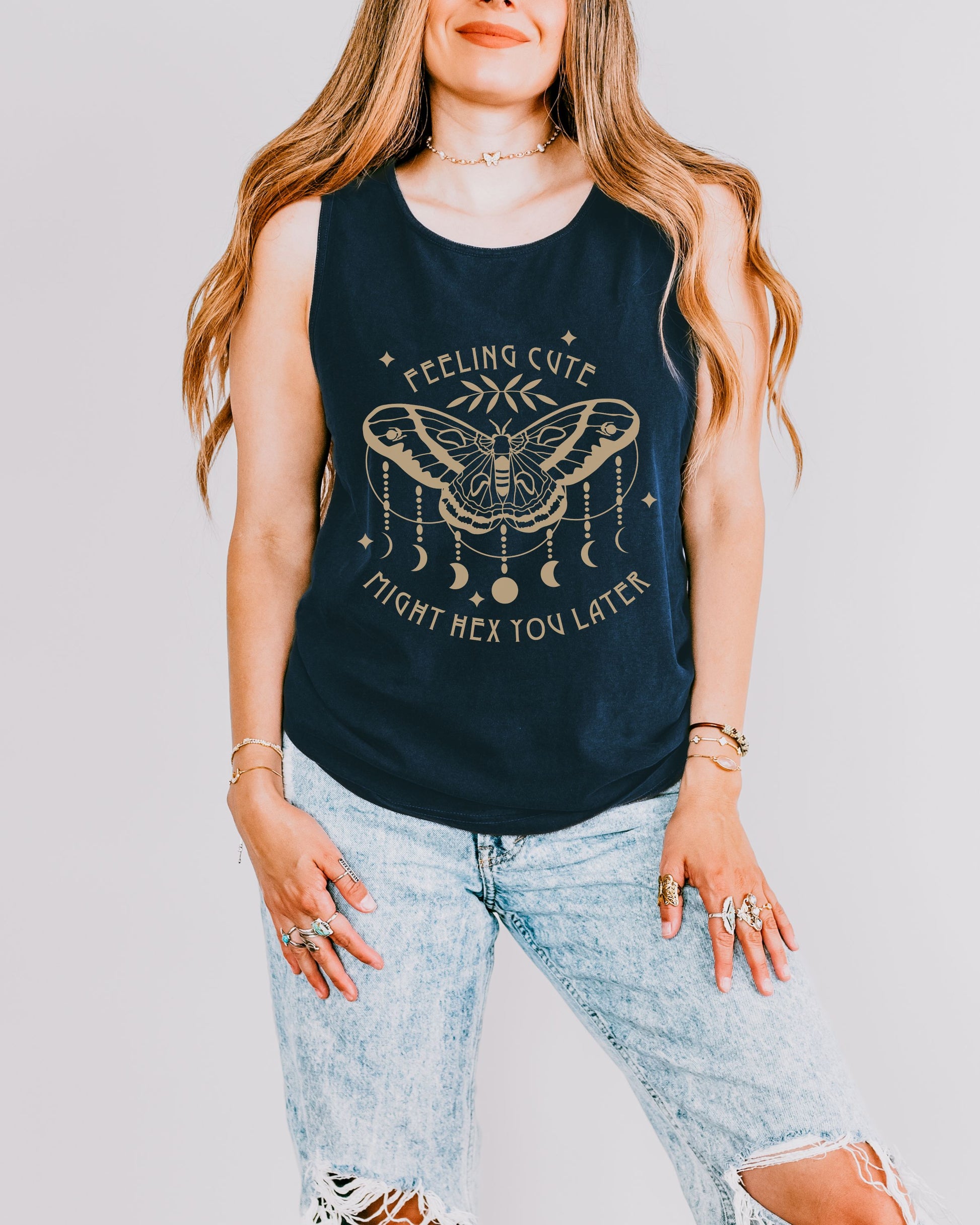 Woman wearing a navy tank top with a graphic design and text.