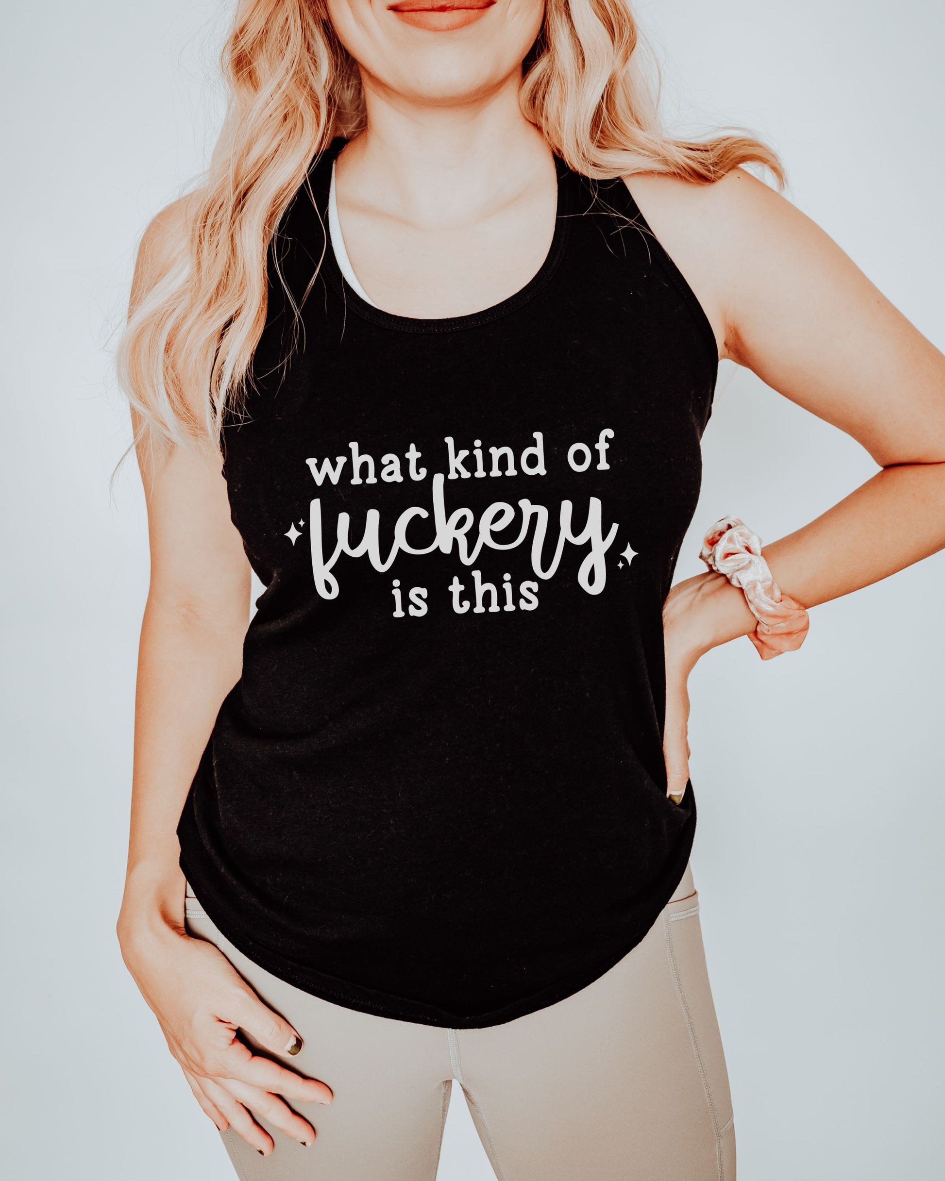 Person wearing a black tank top with white text on a plain background